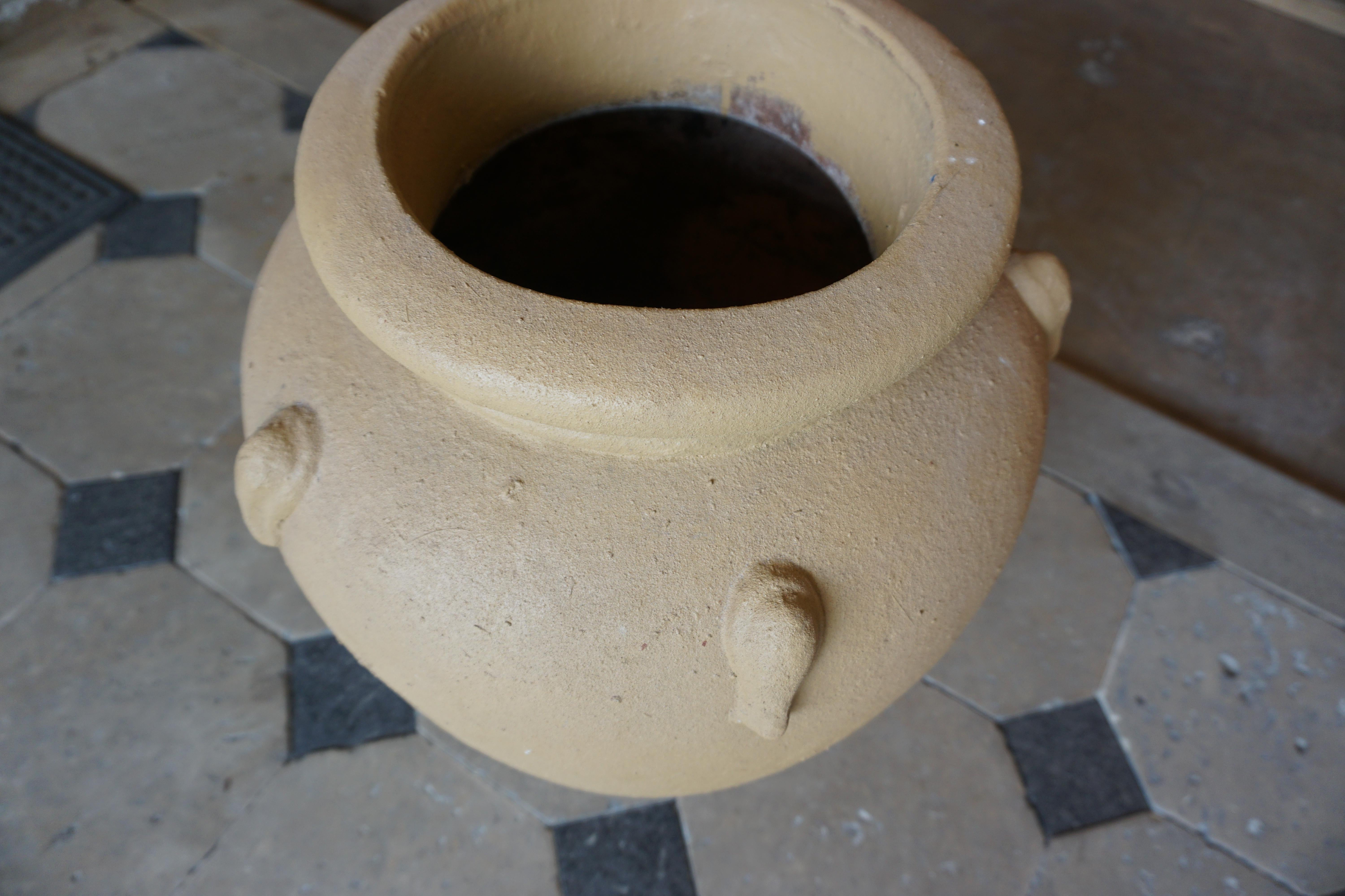 Two terracotta planters in a golden hue. Measurements: 16'' D x 23'' H
