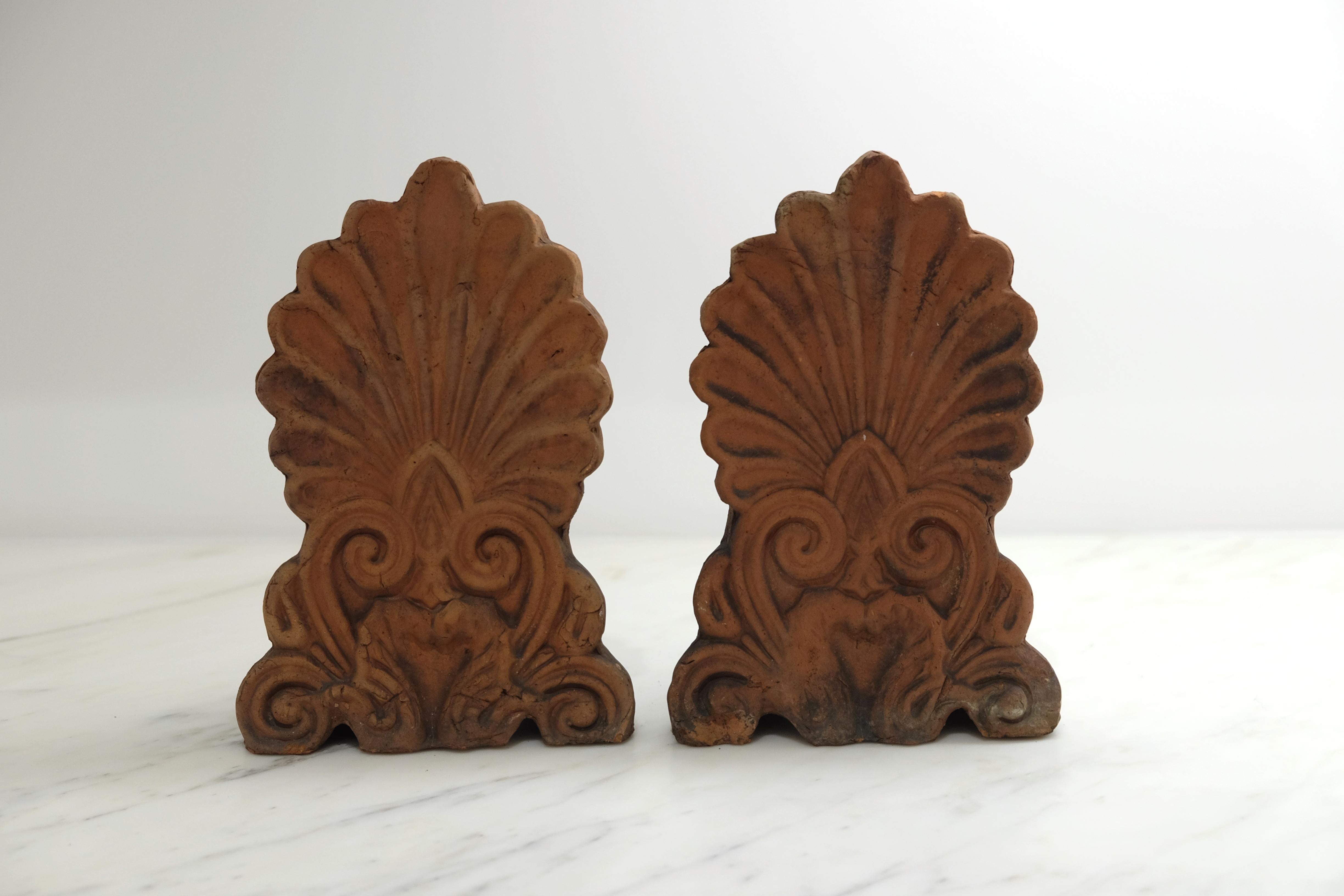 Pair of terracotta anthemion roof tiles, circa 1880. Anthemion was a design consisting of a number of radiating petals, developed by the ancient Greeks from the Egyptian and Asiatic form known as the lotus palmette.