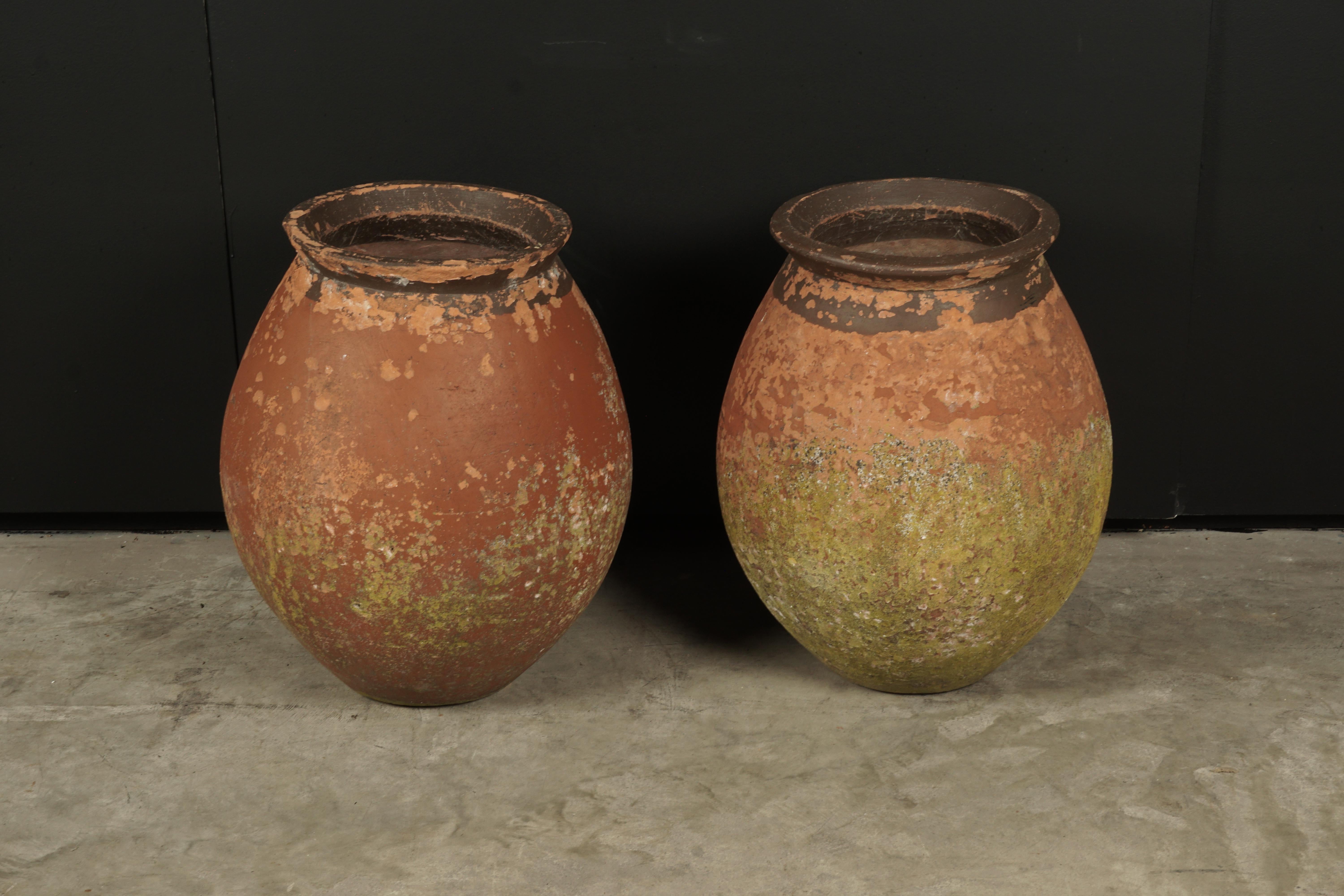 Rare pair of terracotta urns from France, circa 1960. Nice original color and patina.