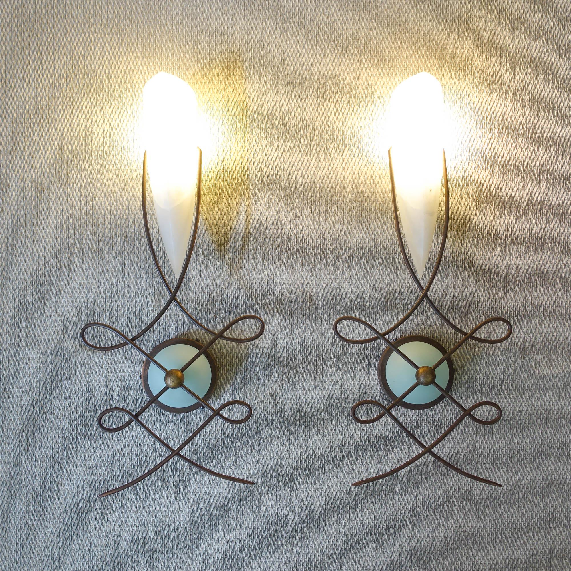 This pair of wall lamps, model Louvre, was designed by Jean-François Crochet for Terzani, in Italy, during the 1980's. These lamps are made of handcrafted metal with a rust finish and a finely crafted cream-colored alabaster shade. The thick