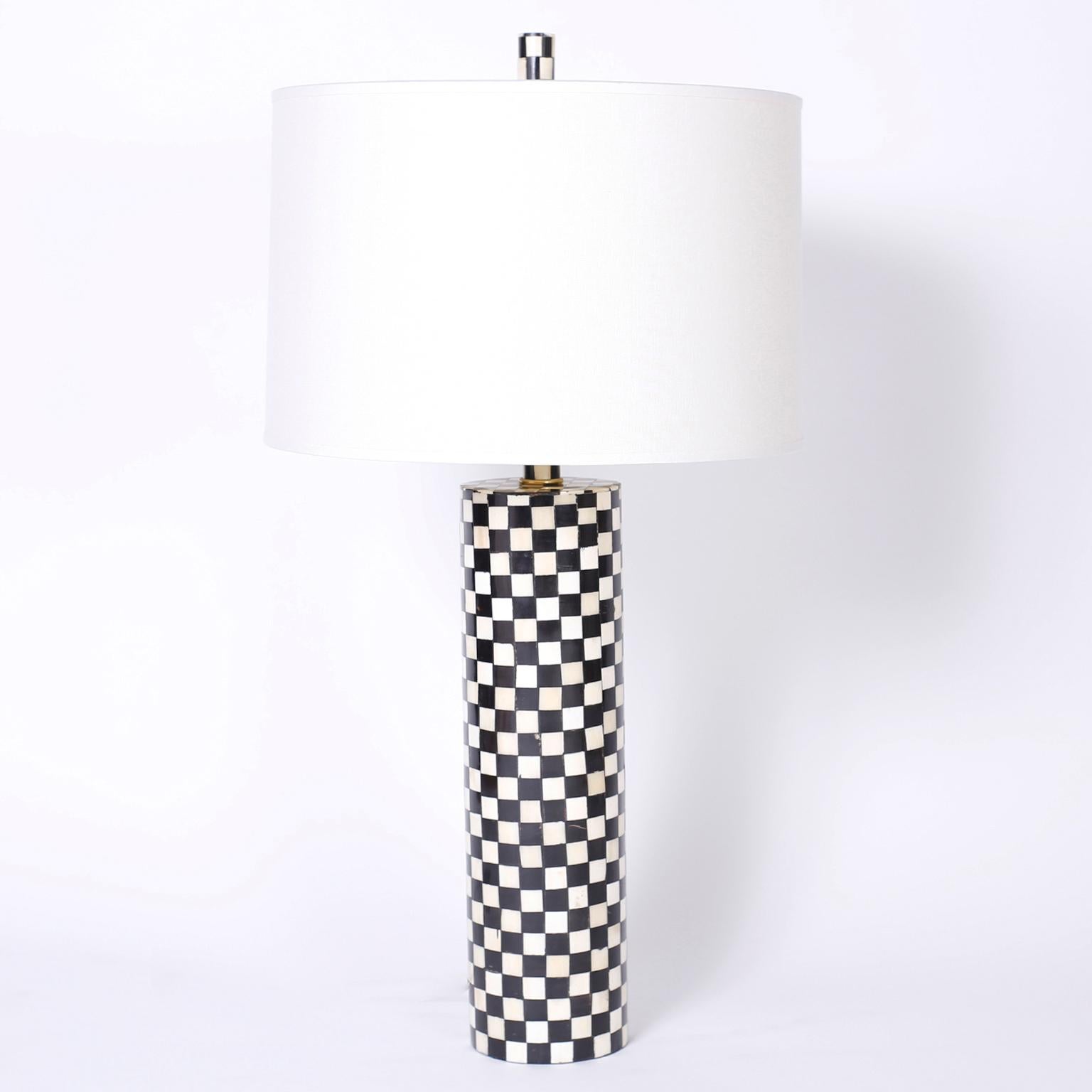Pair of midcentury table lamps with a sleek modern form tessellated with bone and colored bone squares on the base and finial.