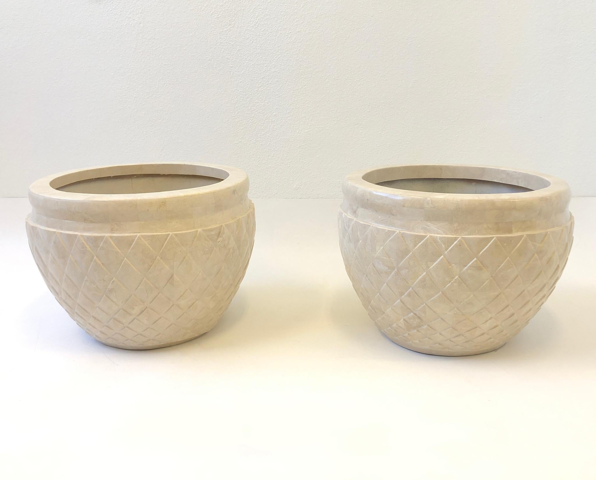 Glamorous pair of 1980s ‘Acorn’ planters designed by Marquis Collection of Beverly Hills.
Constructed of fiberglass covered with tessellated beige fossil stone.
Measurements: 21” Diameter and 16” High.