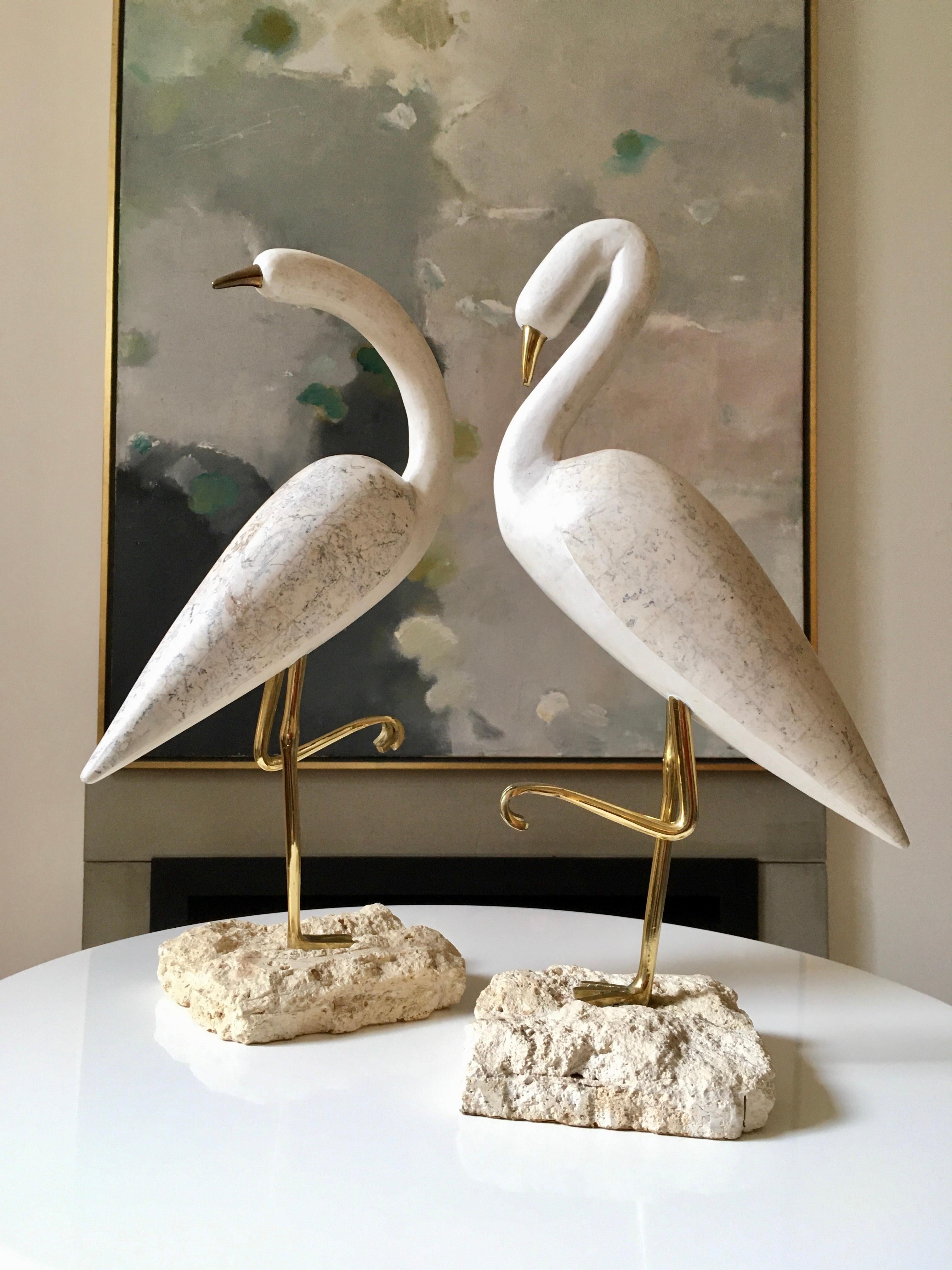 Pair of tessellated marble and travertine stone Heron with forged solid brass legs, mounted on rough hewn stone bases. A thin layer of soft felting to base to prevent damage to surfaces. Very nicely made. 

In excellent condition, these birds make