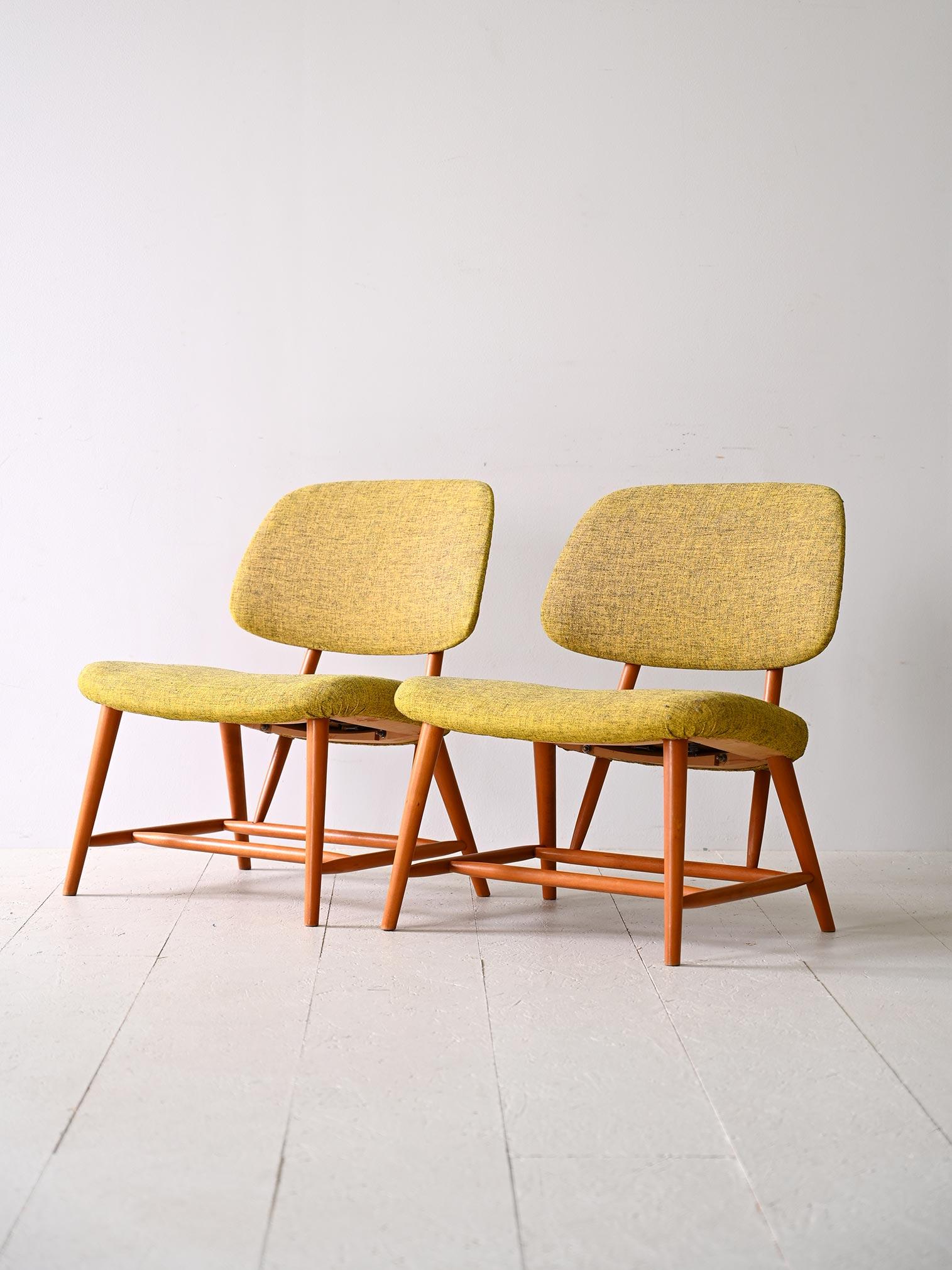 This pair of vintage Scandinavian 'TeVe' or 'TV Chairs' were designed by Alf Svensson, (there is a stamp of authenticity present under the seat).

The solid frame is made of beech wood and has tapered legs, while the seat is delicately upholstered