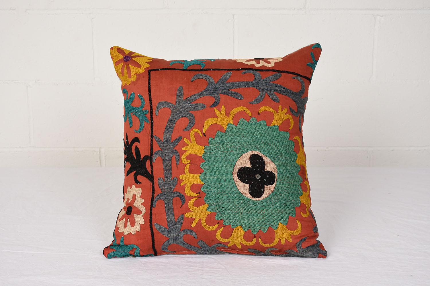 Pair of textile pillows with a colorful design and beaded details.