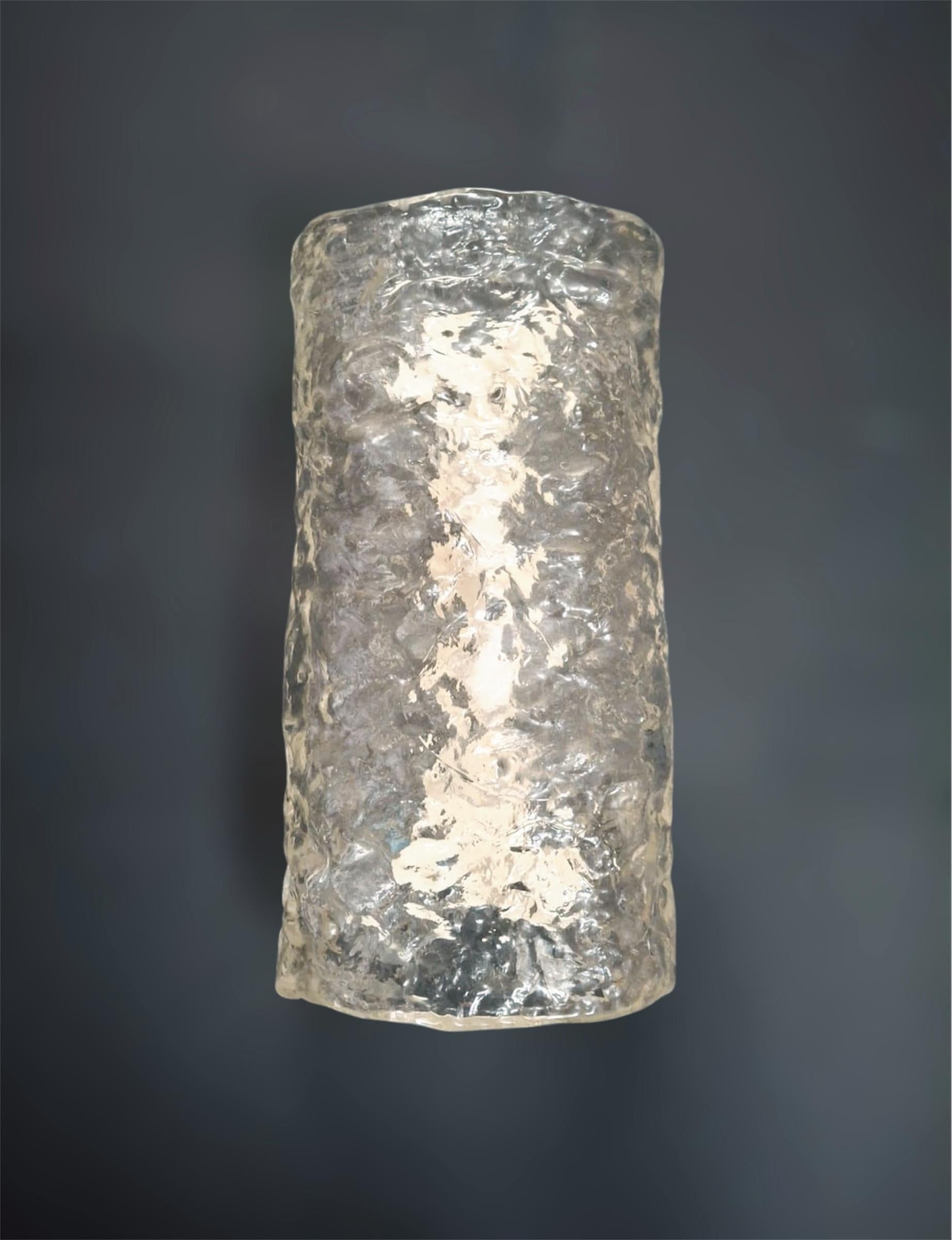 Italian wall lights with clear textured Murano cylindrical diffusers mounted on metal frames / Made in Italy by Mazzega circa 1960s
Measures: height 13.5 inches, width 7 inches, depth 4.5 inches
2 lights / E12 or E14 type / max 40W each
1 pair