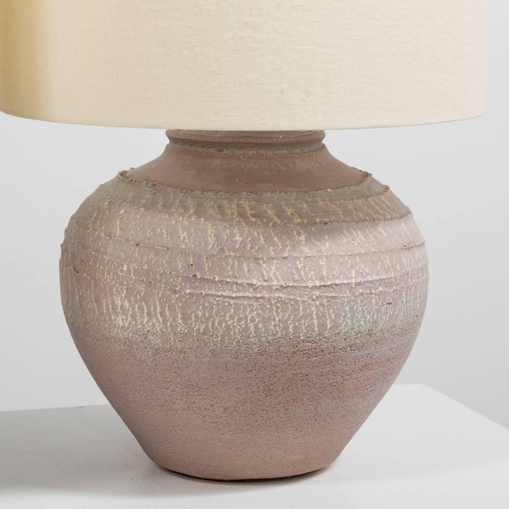 Pair of table lamps made with textured pottery in pastel colours in an urn shape with new linen shades, 1970s.
      