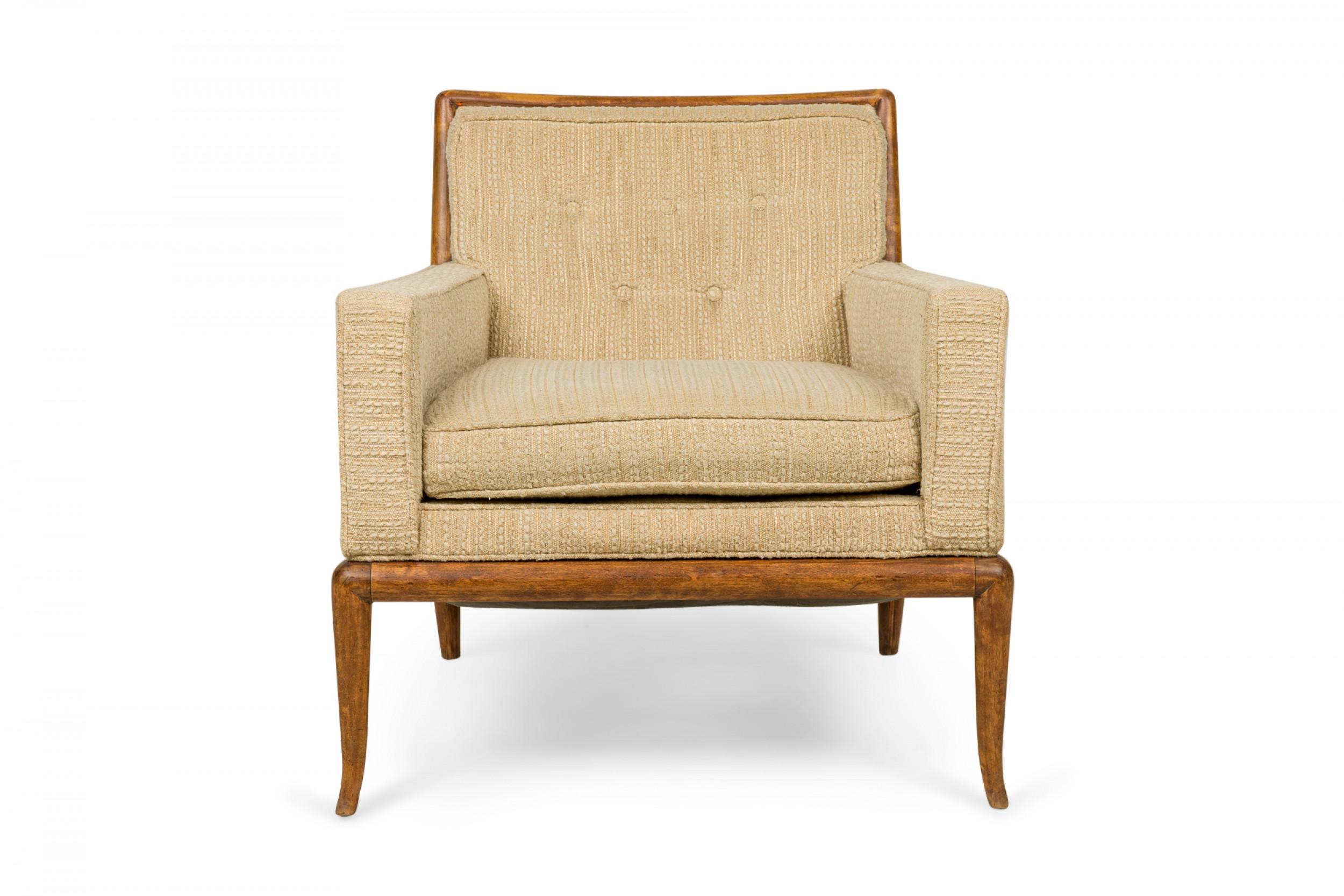 Pair of American mid-century lounge / armchairs with textured beige fabric upholstery with removable seat cushions and a walnut frame, resting on four gently curved and tapered walnut legs. (T.H. ROBSJOHN-GIBBINGS FOR WIDDICOMB FURNITURE