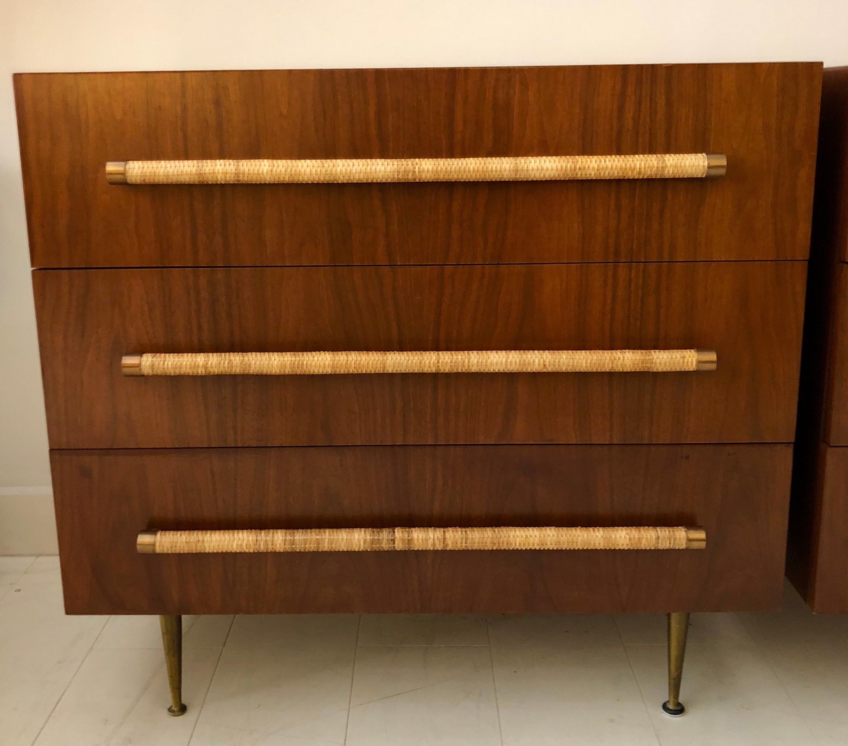 Pair of Classic T.H. Robsjohn-Gibbings for Widdicomb three-drawer cabinets in beautiful original finish dark walnut, with brass legs, and raffia cane wrapped handles. Signed with remnants of cloth Widdicomb label.