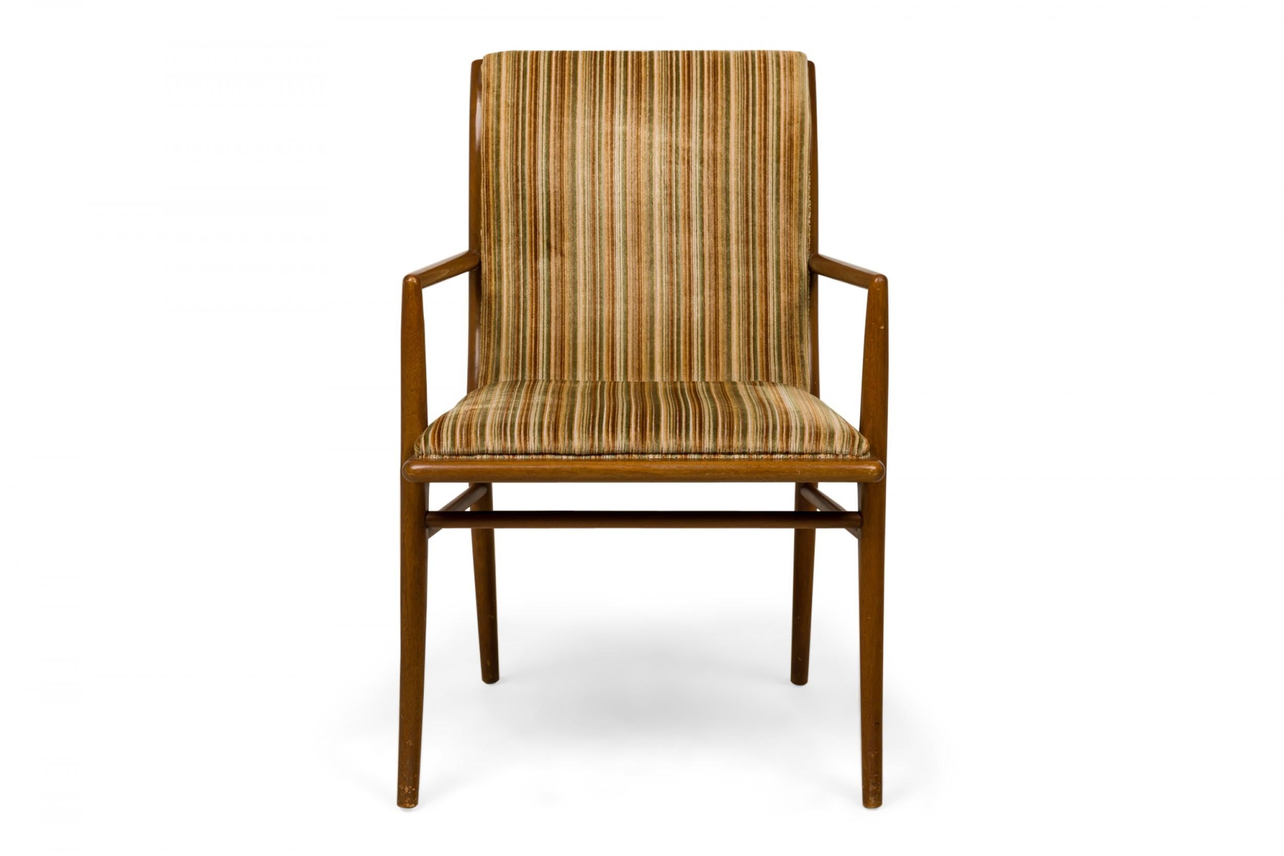 PAIR of Mid-Century dining armchairs with beige and gold striped fabric upholstery and a walnut frame with thin delicate arms, and curved slat backs, resting on four tapered legs. (T.H. ROBSJOHN-GIBBINGS FOR WIDDICOMB FURNITURE COMPANY)(PRICED AS