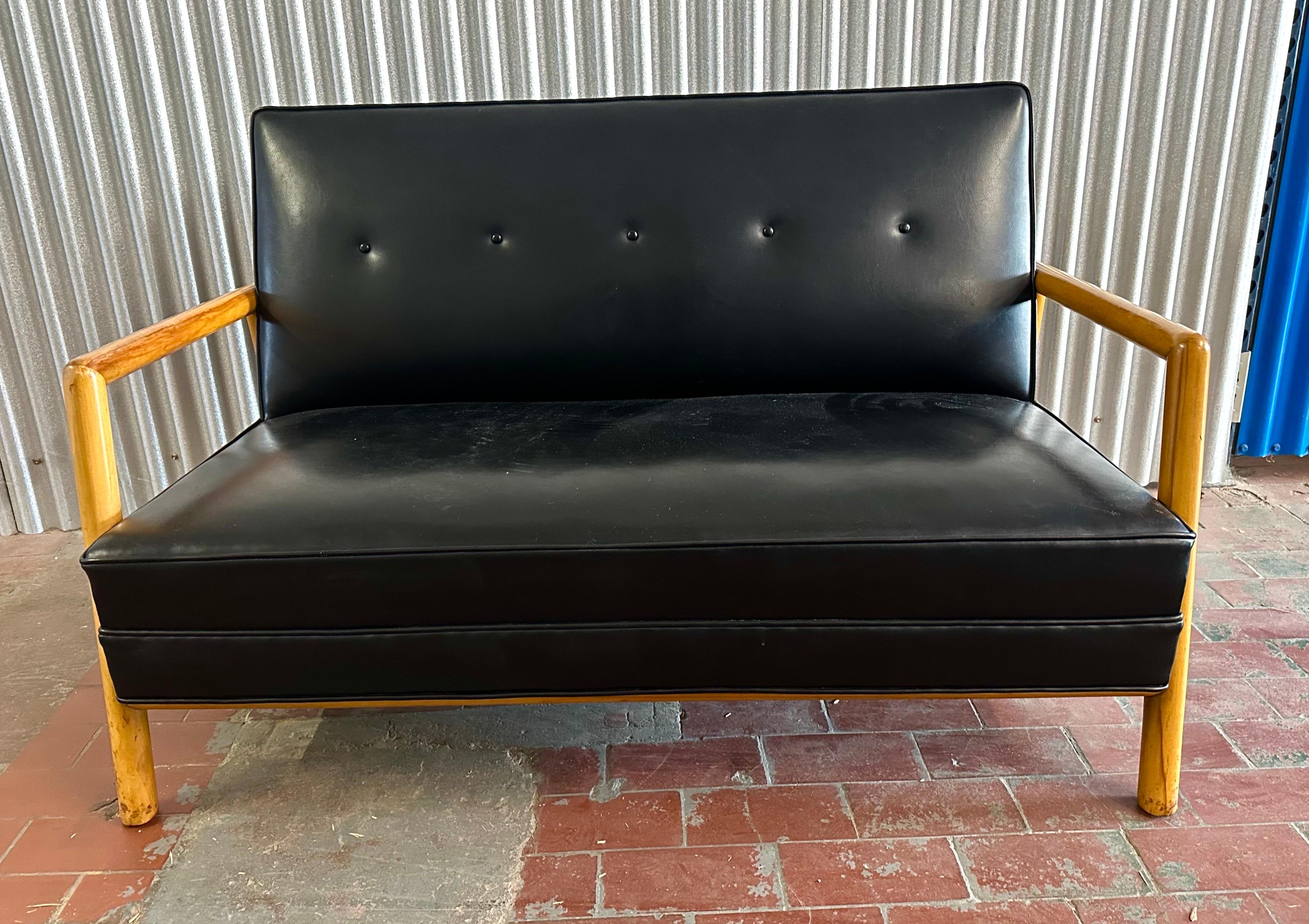 A great Robsjohn-Gibbings design in bleached walnut. The chunky open dowel frame has a sharp architectural look.  The original finish has acquired a beautiful warm patina, and the original faux patent leather upholstery is in clean condition.  This