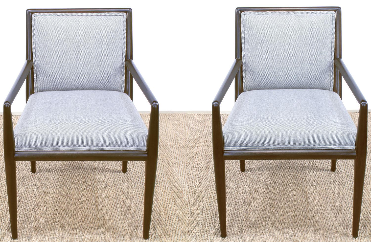 Pair of expertly restored sleek lined arm chairs designed by T. H. Robsjohn-Gibbings for Widdicomb. Holland & Sherry wool upholstery in a grey and white very small checker board pattern. Satin finish to the dark walnut stain. A great pair of chairs