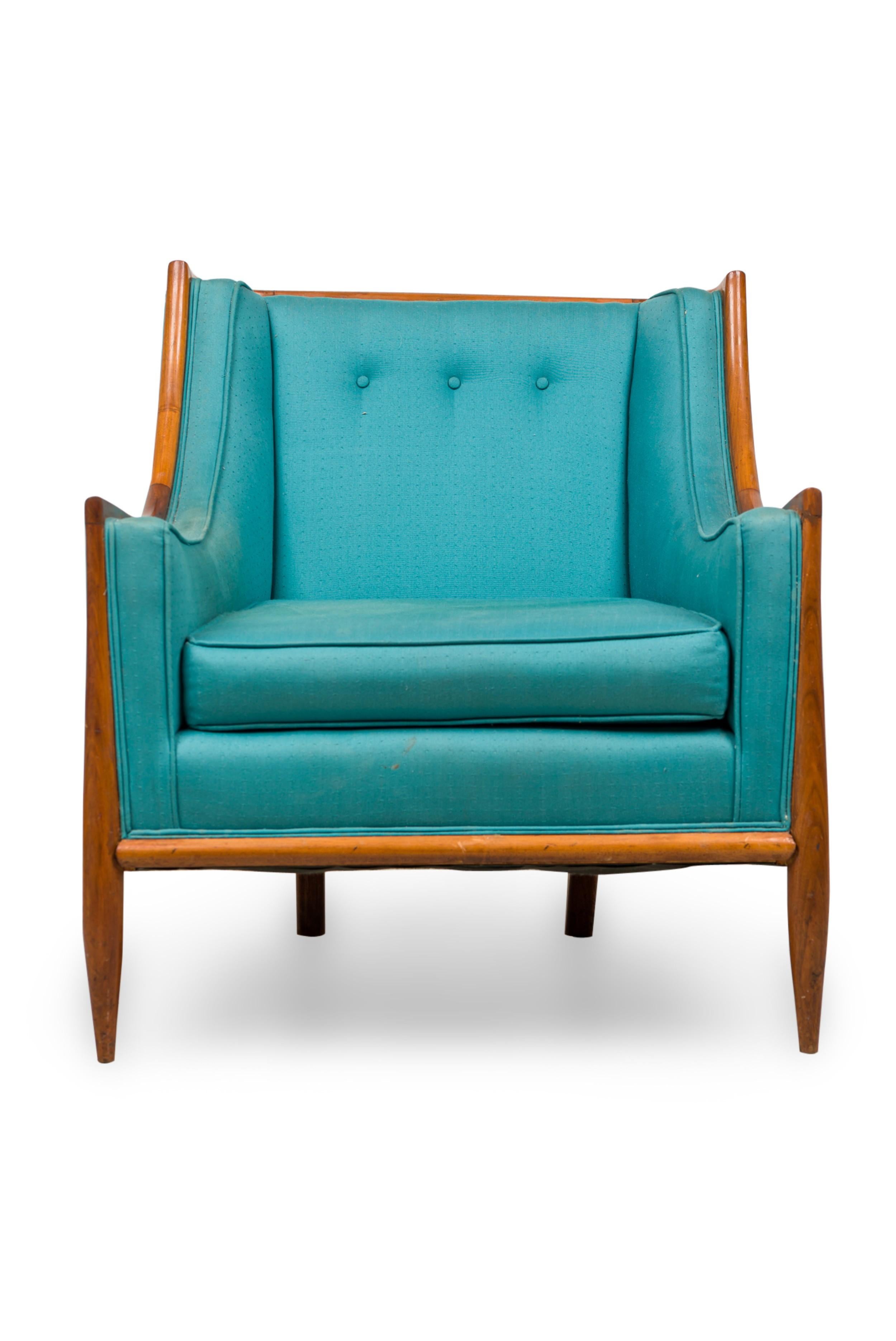 PAIR of Mid-Century Modern bergere armchairs with walnut frames, upholstered in a blue / teal textured fabric, resting on four tapered walnut legs. (T.H. ROBSJOHN-GIBBINGS)(PRICED AS PAIR)

