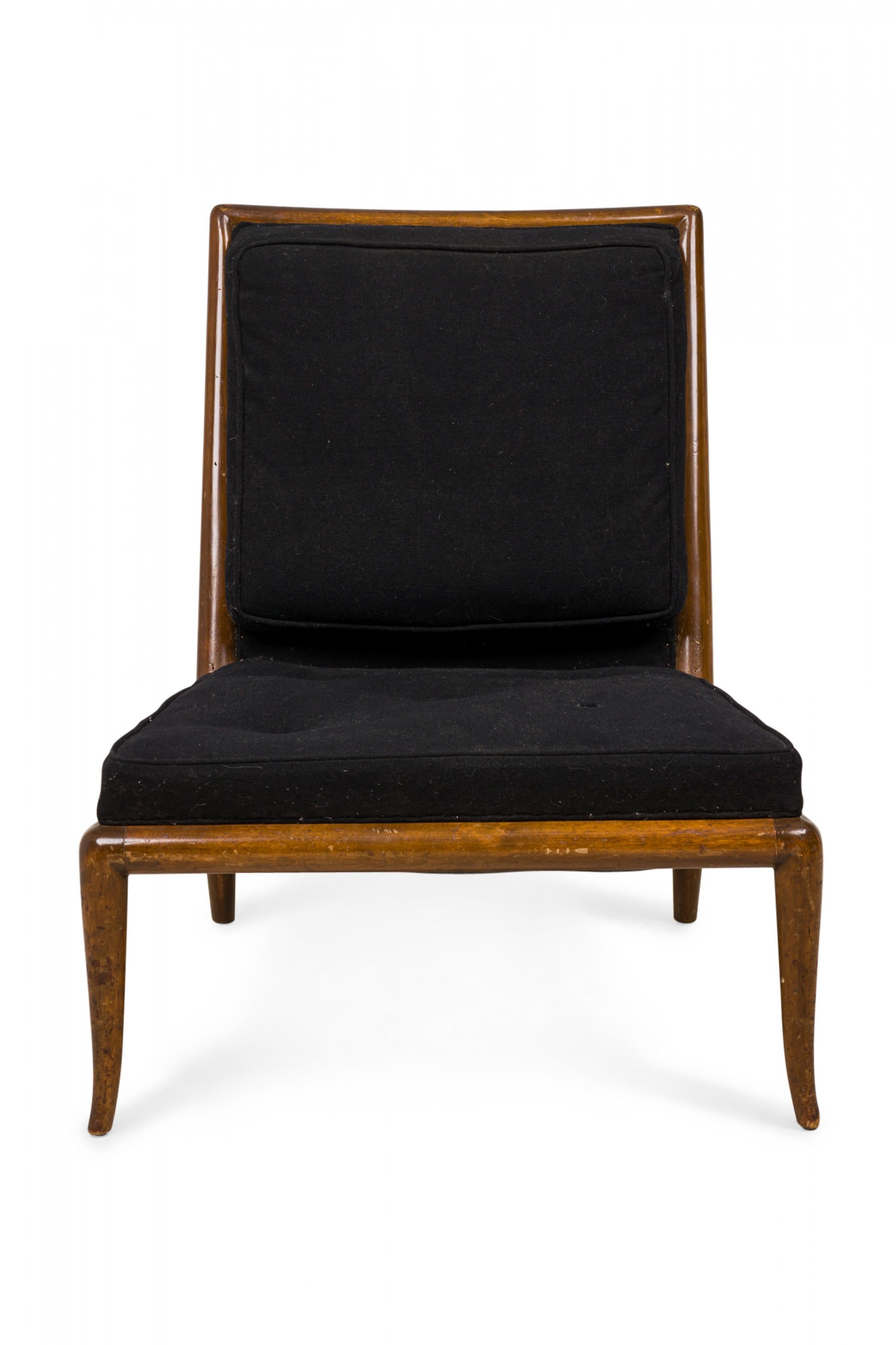 PAIR of Mid-Century slipper / side chairs with black fabric upholstery with button tufted detail, and a walnut frame, resting on four gently curved and tapered legs. (T.H. ROBSJOHN-GIBBINGS FOR WIDDICOMB)(Similar pieces: DUF0544, DUF0545)
