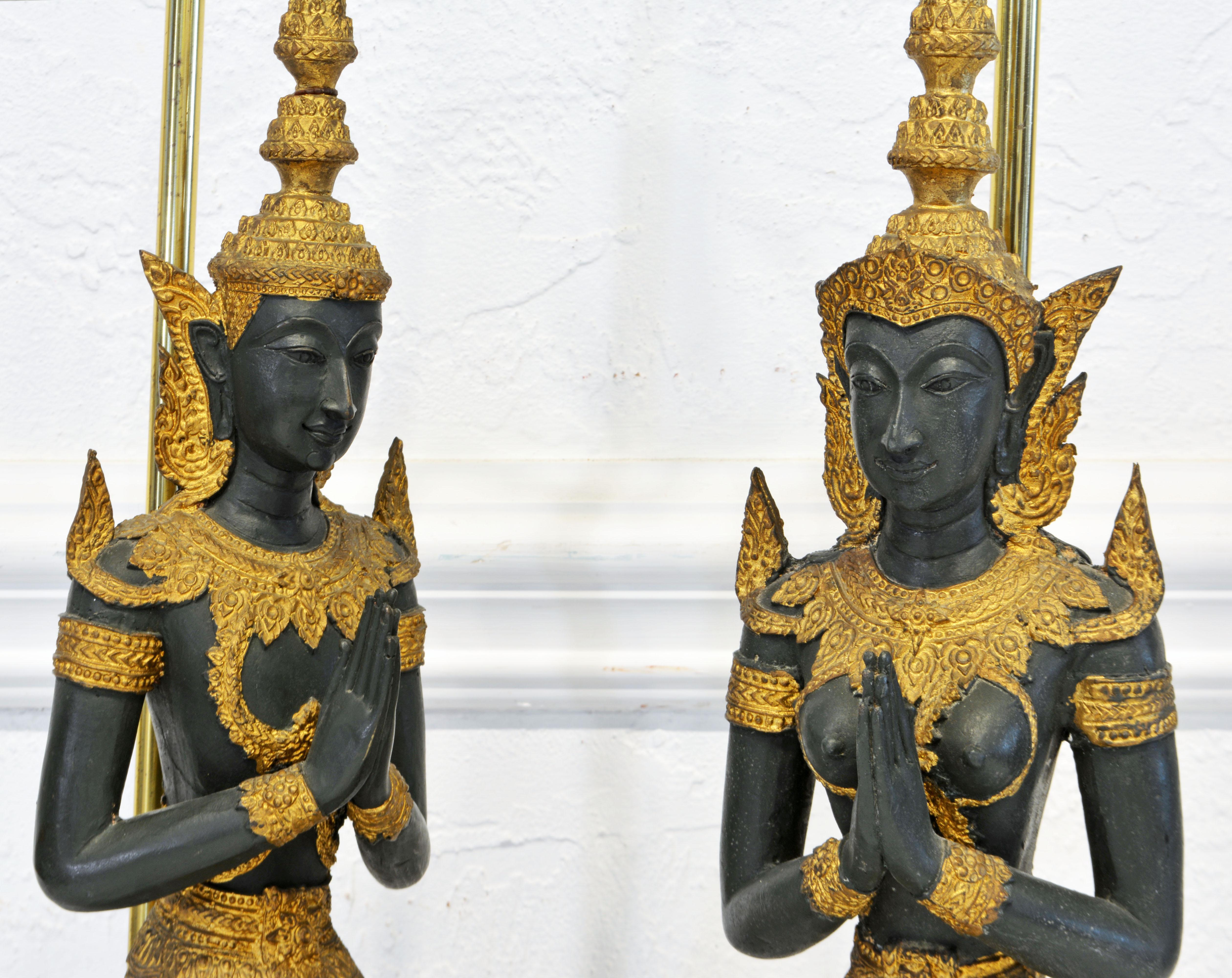 This mid 20th century pair of Thai bronze nale and female tempel guards feature a stunning combination of dark green bodies and flowing gilt costumes with rich tecture. Everuthing is intricately detailed. They are hand made and not part of an