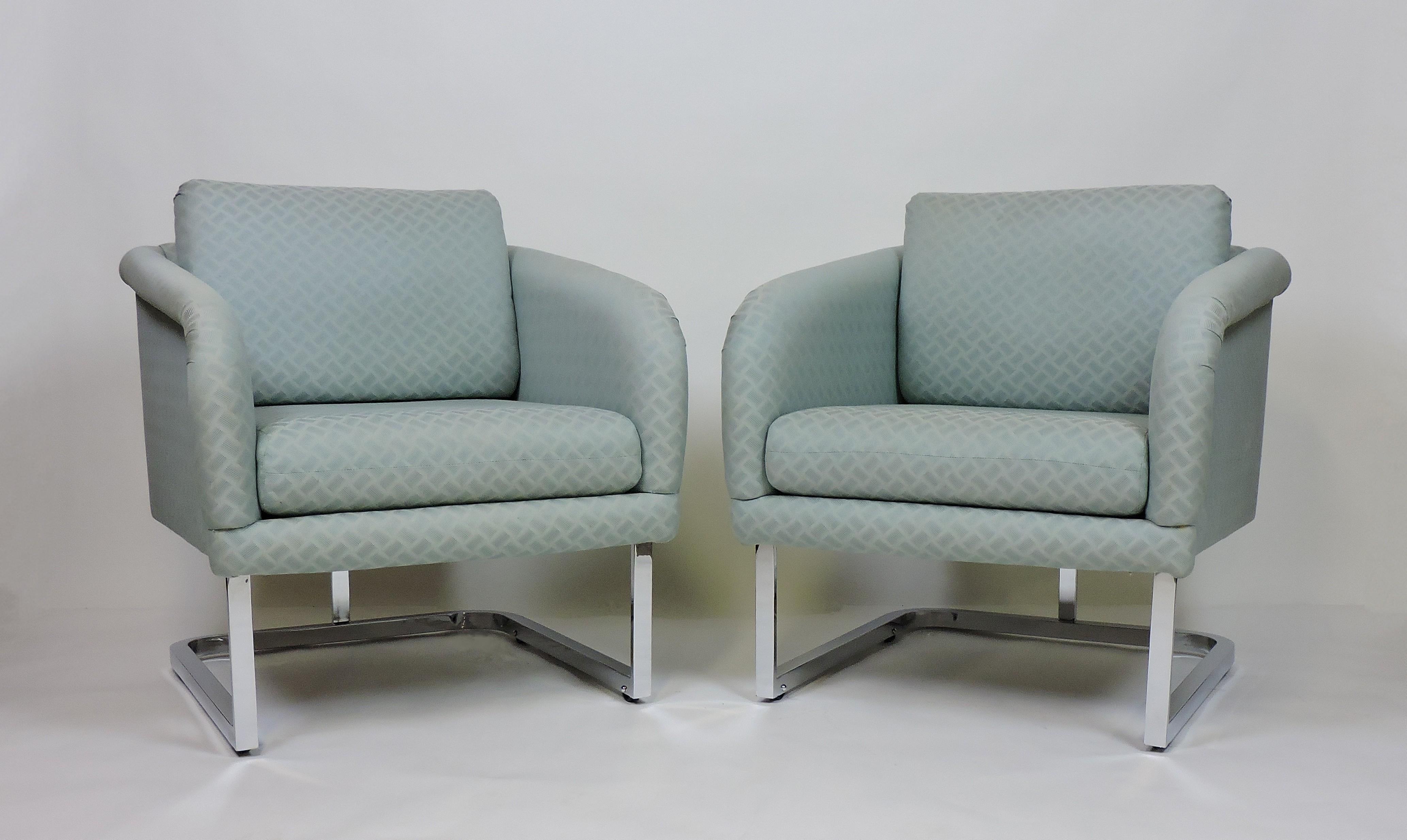 Beautiful pair of lounge chairs manufactured by high quality furniture maker, Thayer Coggin. These chairs are very well constructed and have chrome bases with hidden wheels which makes them easy to move. They have the original pale green fabric and