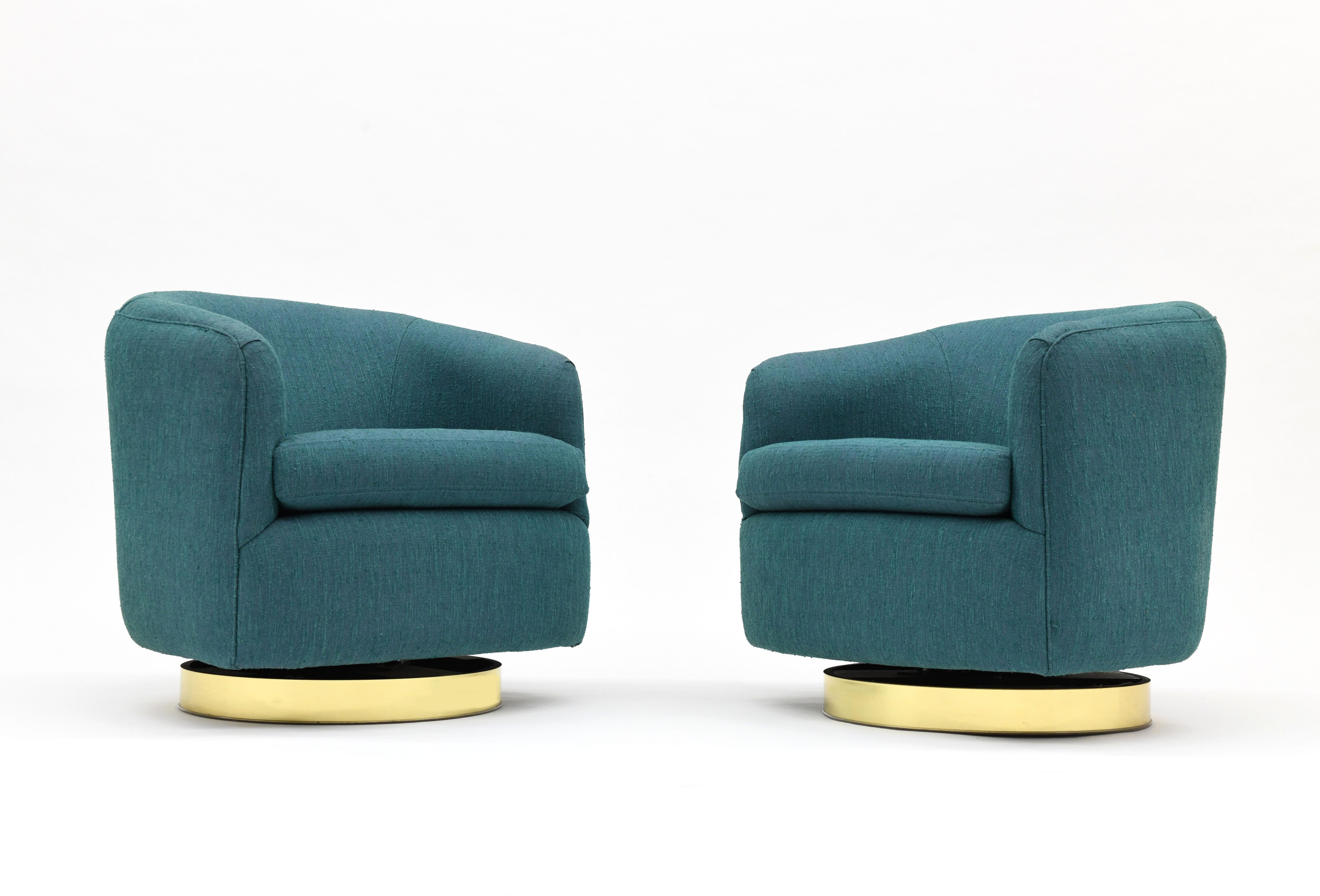 Excellent pair of barrel lounge chairs by Milo Baughman for Thayer Coggin. Chairs swivel and tilt back. Bases are round with brass detailing. Chairs retain the Thayer Coggin label.