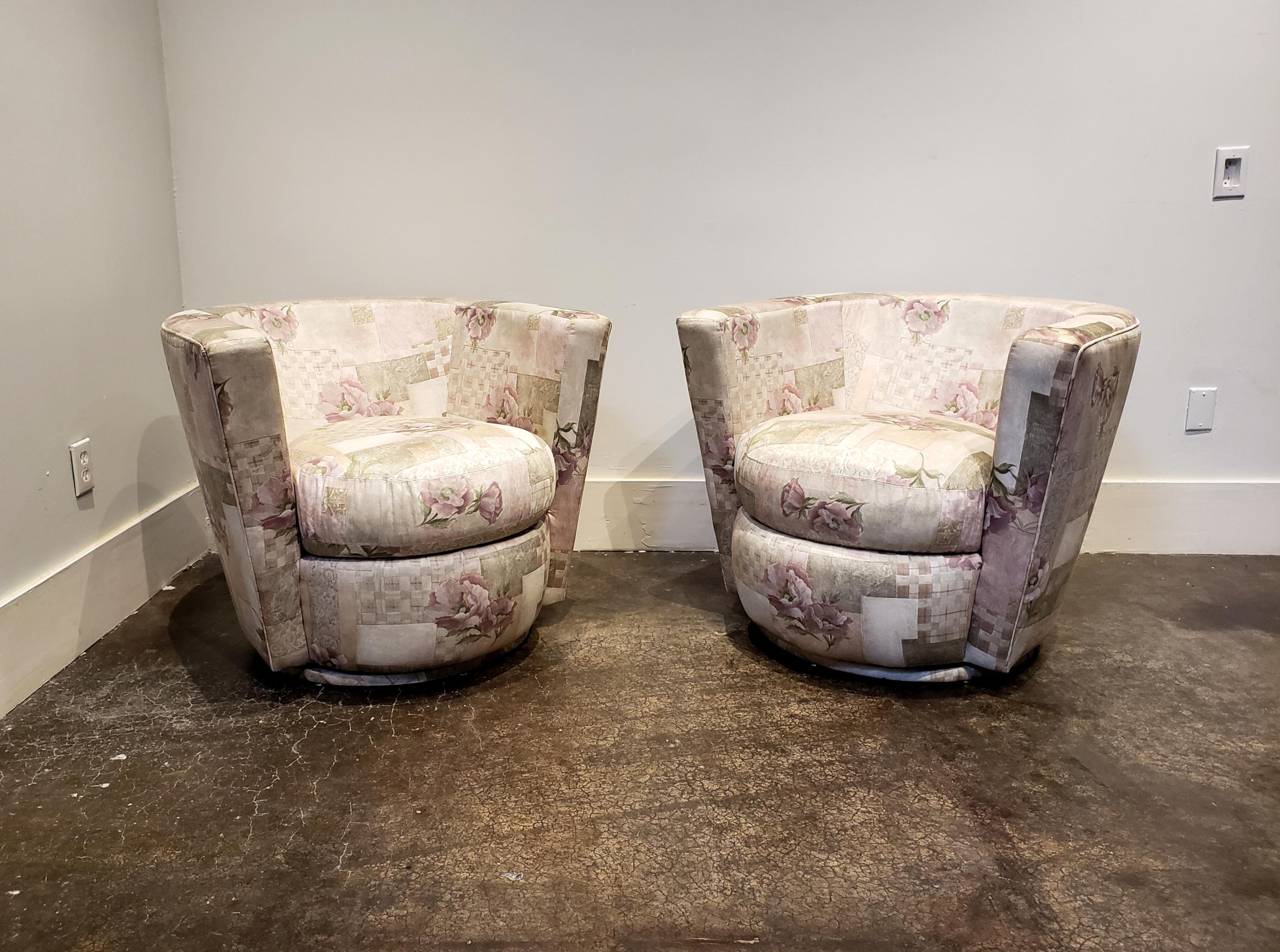 Pair of Thayer Coggin swivel tub chairs from the 1990s with original tags and tasteful floral pastel upholstery. Strong architectural shape paired with cushy comfort. Upholstery is in good shape with minor edge wear (see picture).