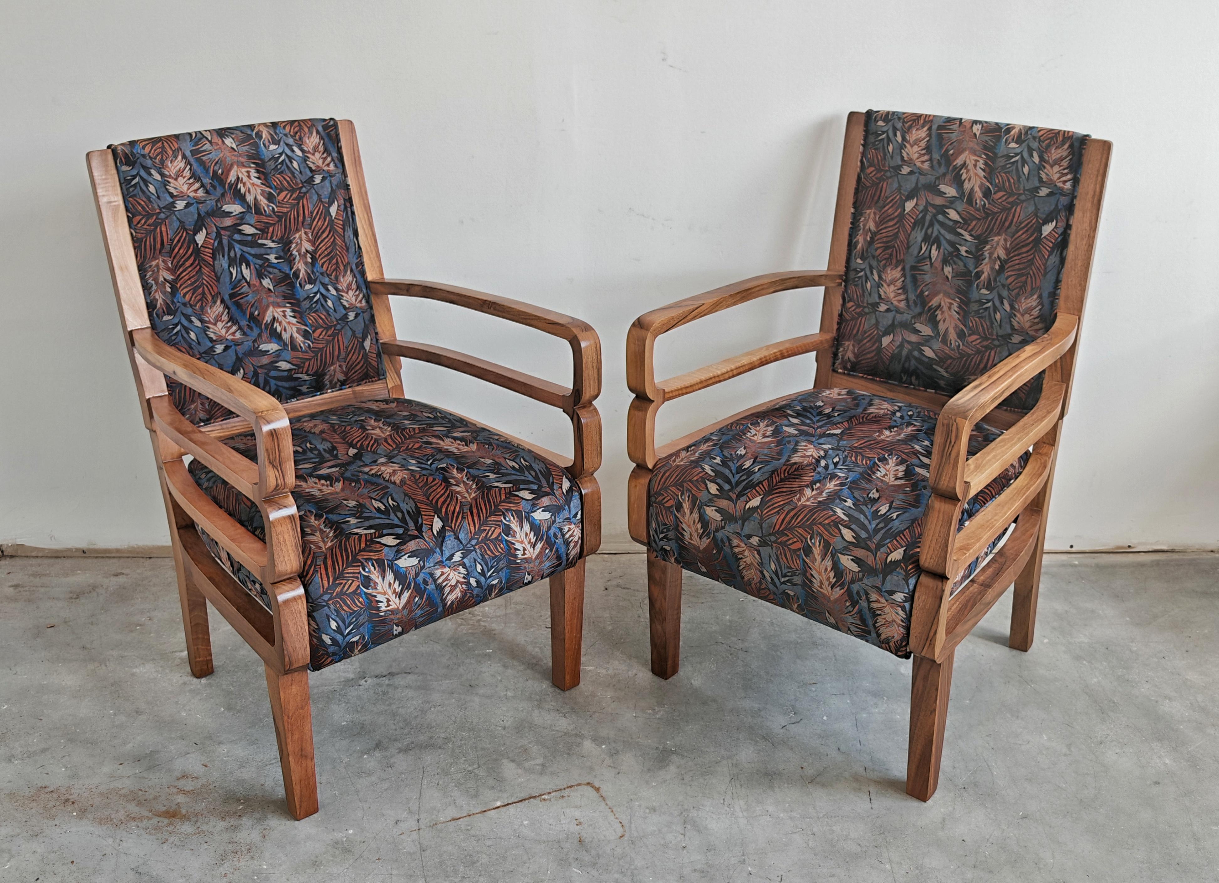 En este anuncio encontrarás un par de sillones Art Déco con reposabrazos de forma única y triple lazo. Los sillones están realizados en nogal macizo con ricas vetas de madera y tapizados en felpa con el estampado floral que representa follajes