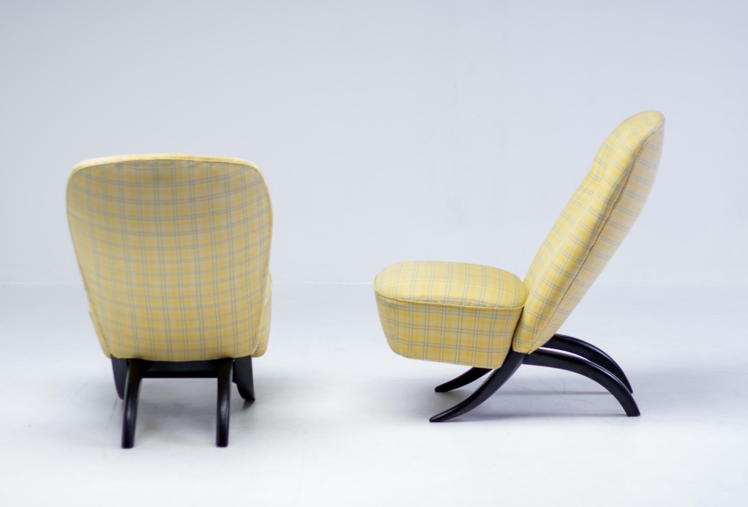 Theo Ruth for Artifort, ‘Congo’ lounge chairs in black lacquered wood and checkered yellow fabric, The Netherlands, 1952. 

These chairs have a unique construction, forced by tension and gravity. The back and seating are two separate elements that