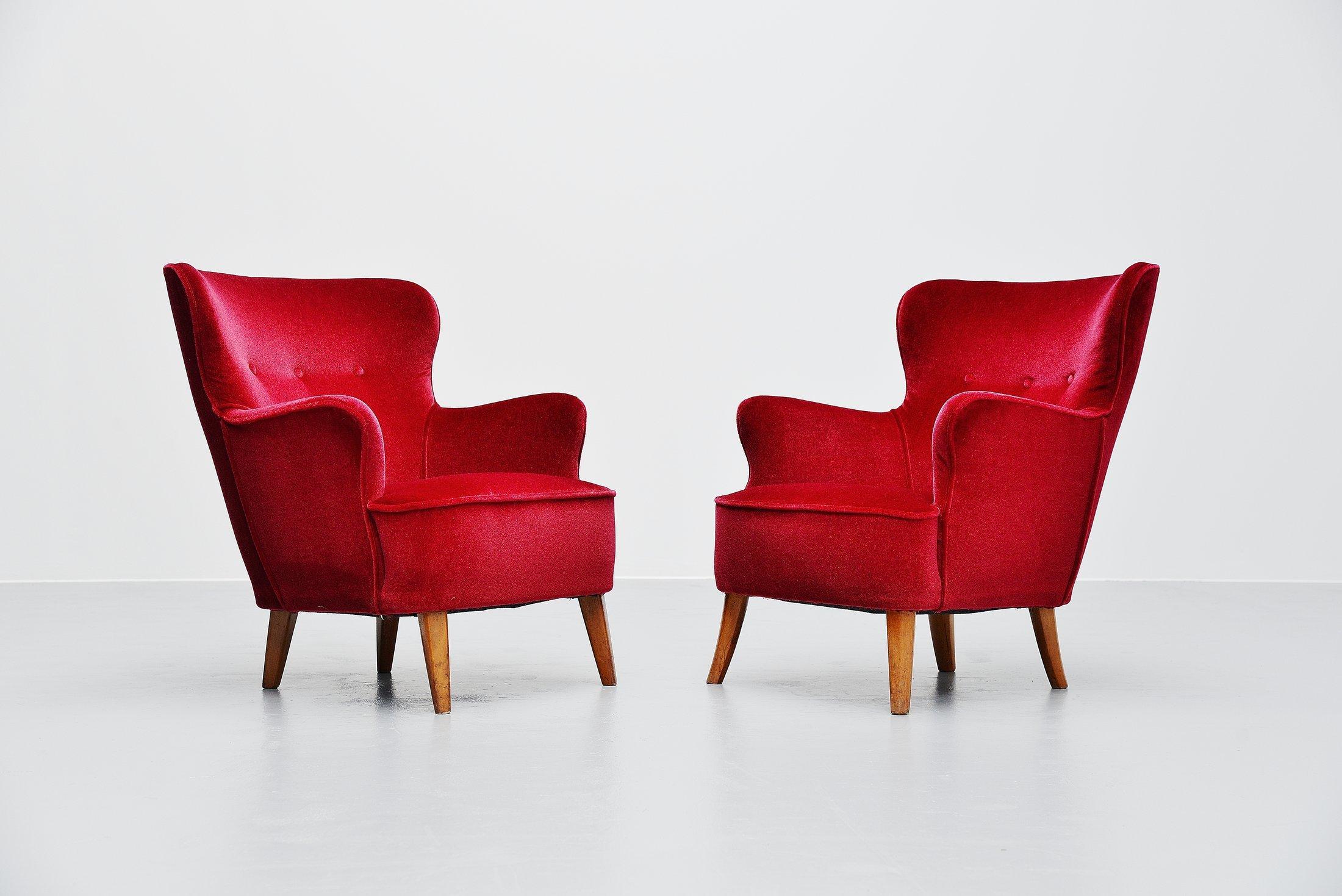 Early pair of cocktail lounge chairs designed by Theo Ruth and manufactured by Artifort, Holland, 1955. These club chairs have very nice lipstick red velvet upholstery which is in fantastic condition. The legs are made of beechwood and are also