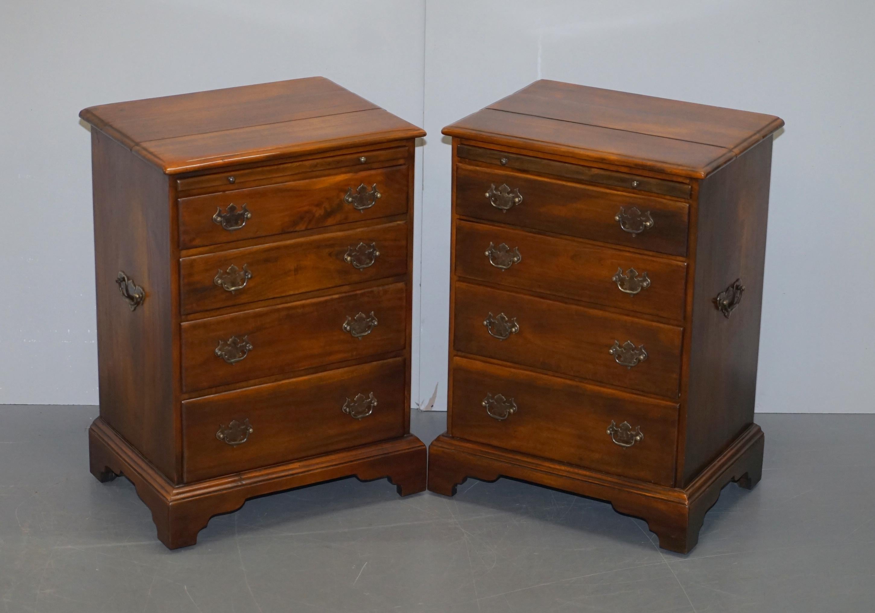 We are delighted to offer for sale this lovely pair of ex showroom condition RRP £3900 Theodore Alexander bedside table sized chests of drawers in the Military campaign style with brown leather topped butlers serving trays

A very good looking