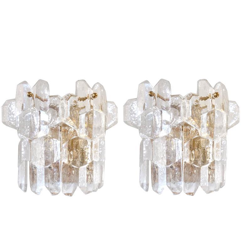 A pair of thick textured clear glass sconces with brass back plates and hardware by J. T. Kalmar/

Austria, Circa 1960's 

Three (3) Pairs Are Available.