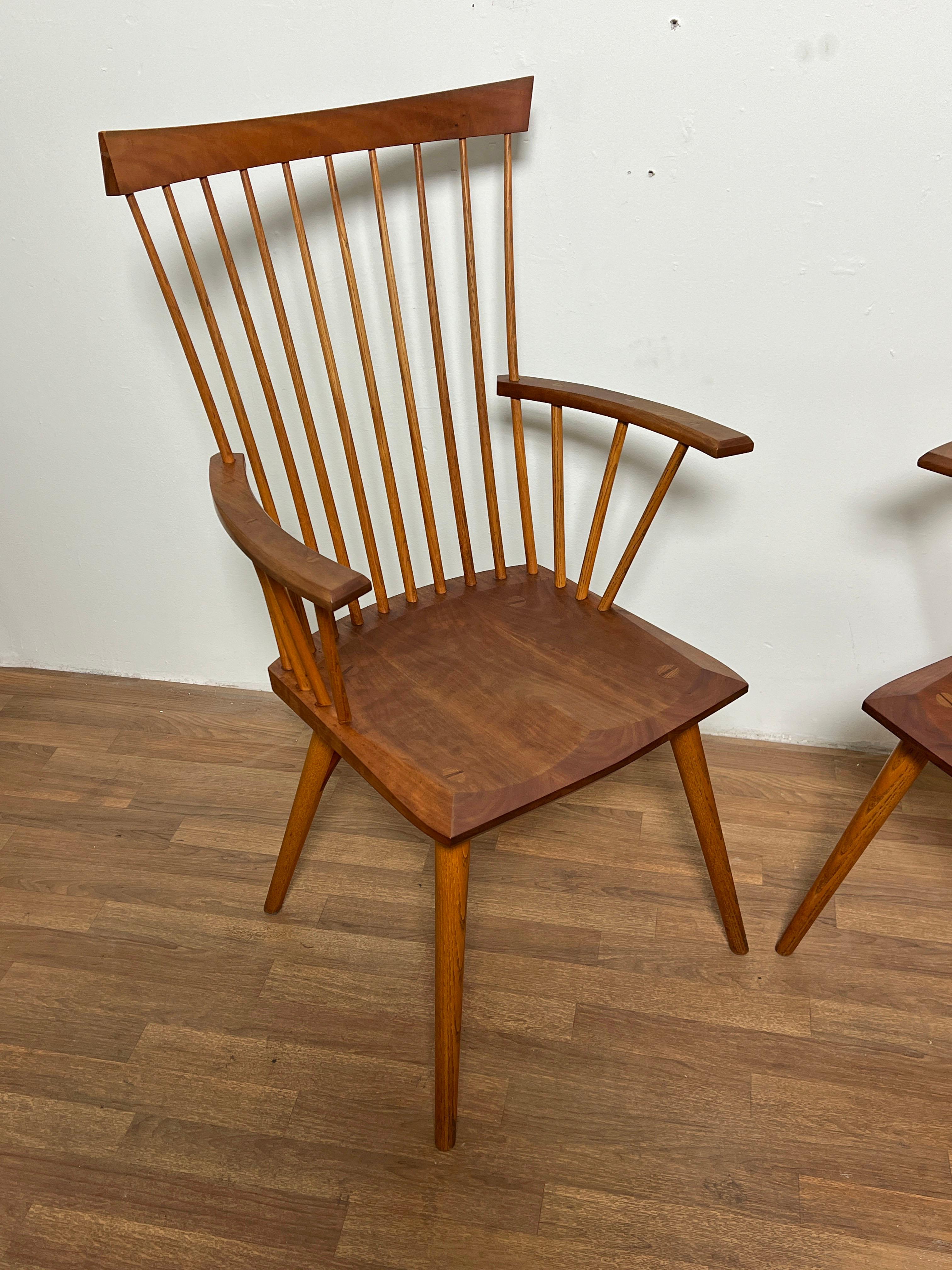 A pair of handcrafted “Eastward” armchairs by Thomas Moser in cherry, dated 1991.