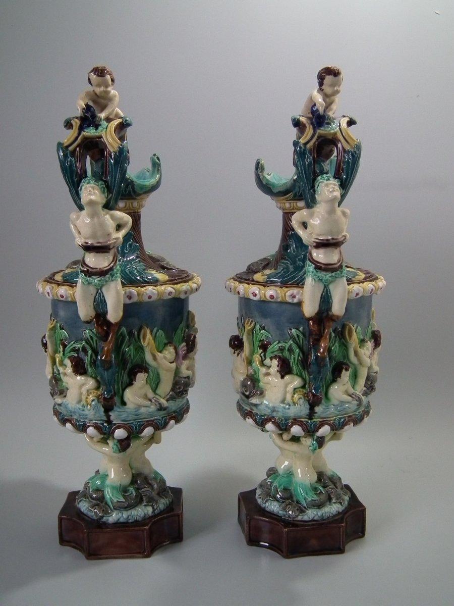 Pair of Thomas Sergent Majolica ewers with a mythological theme which feature faun handles, mermaid bases, hippocamp, dolphins and putti. The piece bears maker's marks for the Thomas Sergent pottery. N.B: Dimensions of each figure are Depth: 6.1ins;