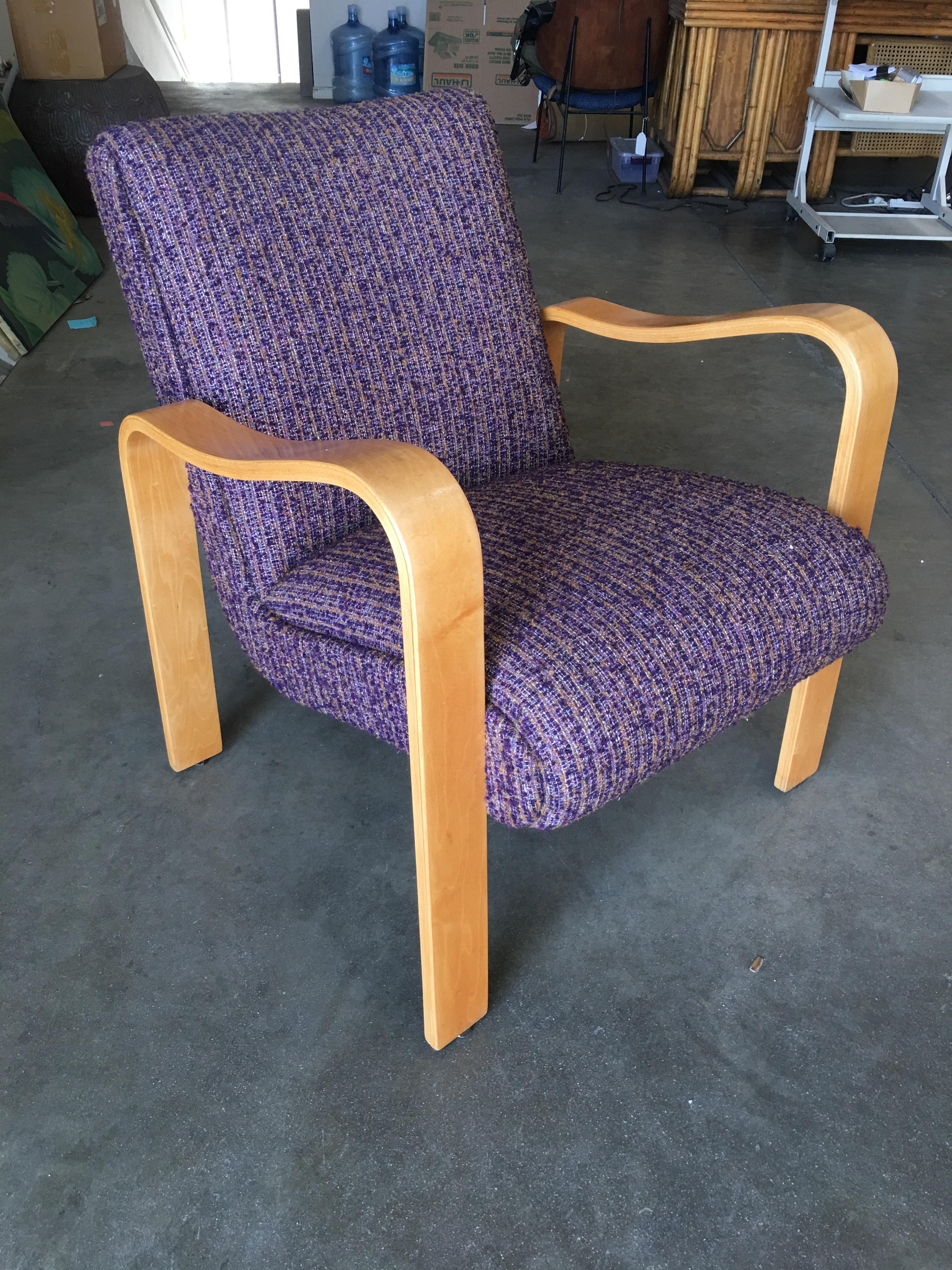 This elegant 1950s lounge chair by Thonet features undulating blond bentwood arms and continues seat. The chair has been professionally recovered in period Purple.