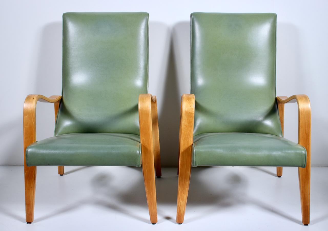 Pair of Thonet Modular Birch Bentwood Lounge Olive Naugahyde High Back Arm Chairs, C. 1950. Featuring smooth organic steamed bent Birch frameworks, with ergonomic upholstered high back and seats. Original vinyl fabric in Light Olive, Pantone 377. 