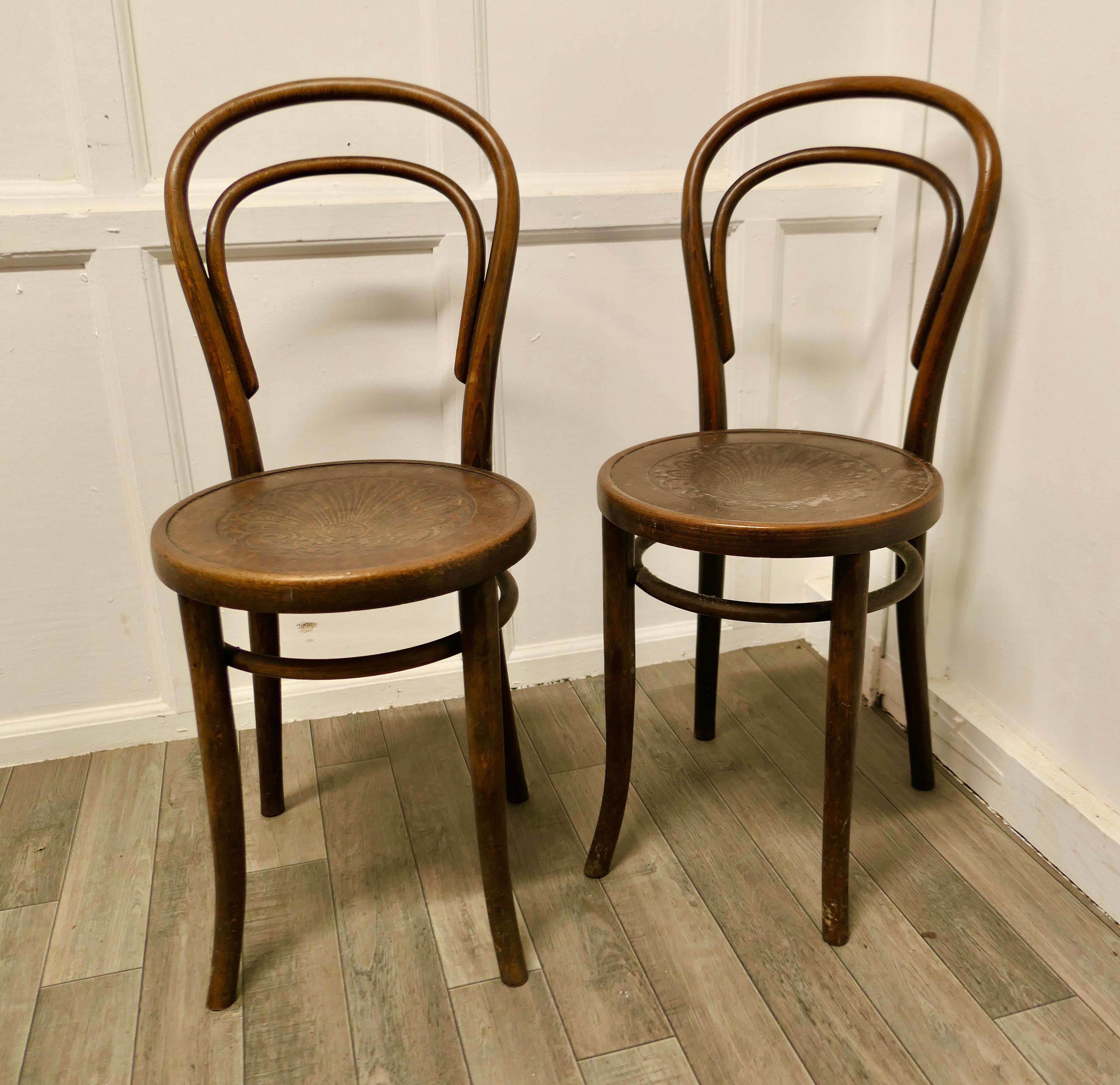 Pair of Thonet Bistro Bentwood chairs 

A Good sturdy pair of Café Chairs, traditionally this type of chair was used in Bistros and Brassieres but they would make just as good kitchen chairs 
The chairs have original patterned pressed plywood