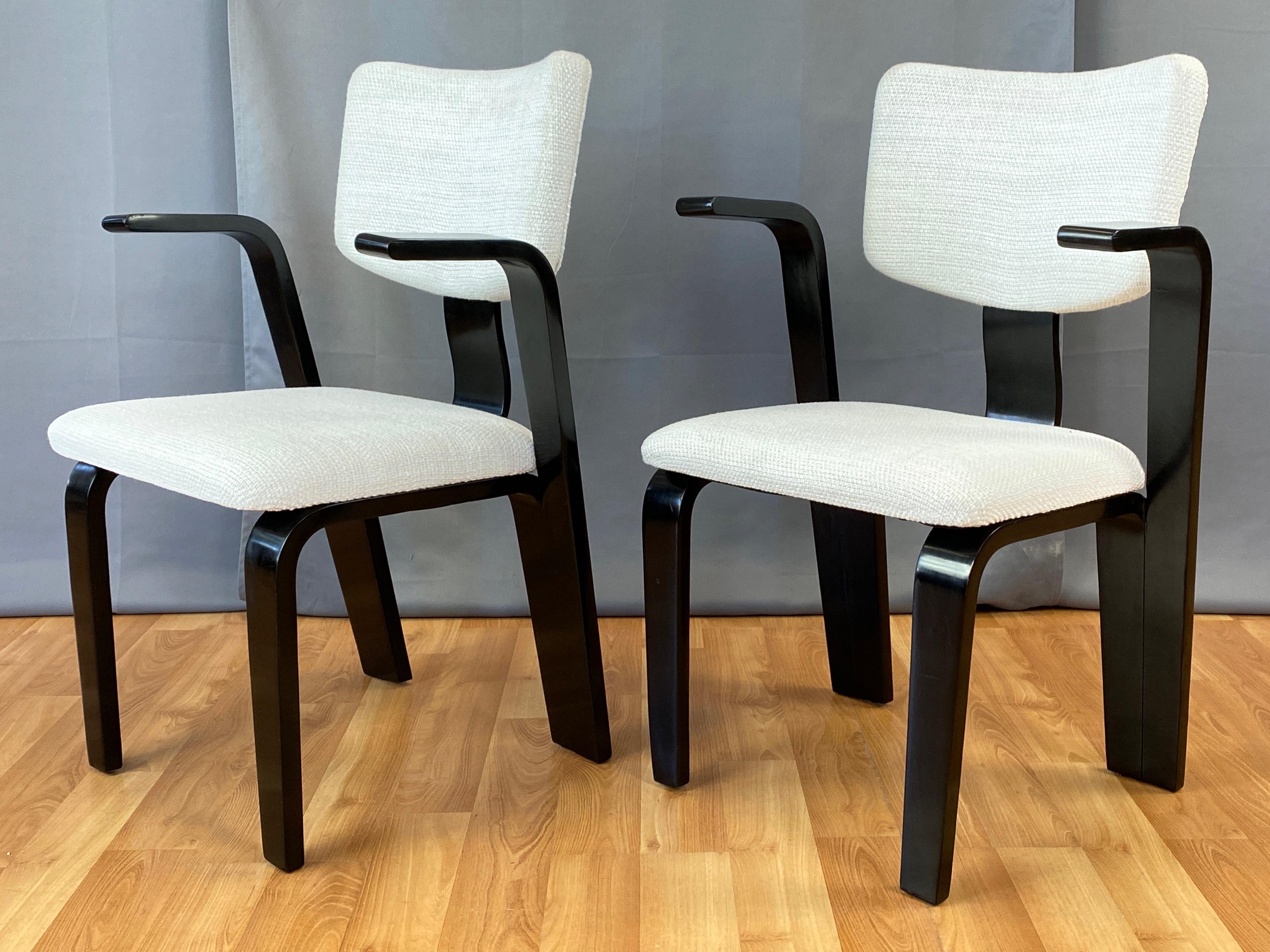 A very dapper pair of uncommon 1940s Thonet bentwood birch armchairs with freshly redone black lacquered finish and white upholstery.

Handsomely crafted frame of flat bentwood elements distinguished by cantilevered arms that split off from the