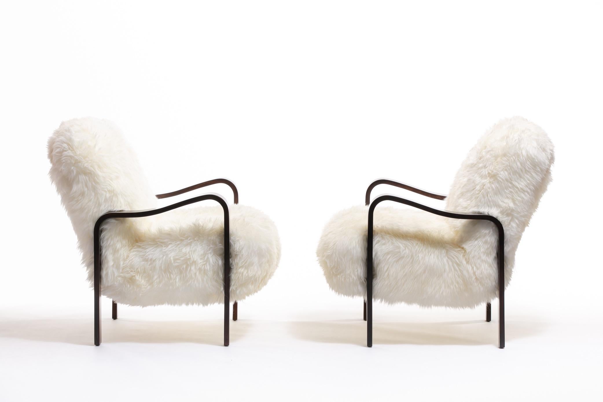 Sculptural but warm and inviting. Lounge on clouds of soft, ivory sheepskins that beckon you to come and stay awhile. We are delighted to bring to market this beautiful pair of Thonet sculptural bentwood and ivory sheepskin armchairs, re-imagined by