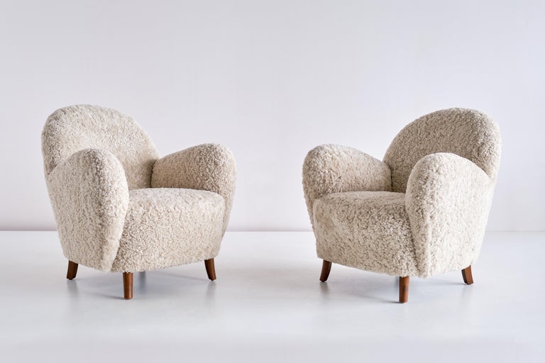 This very rare pair of armchairs was produced by the cabinetmaker Thorald Madsen in Denmark in the mid 1930s. The curved, round shape of the armrests and back gives the design a distinctive and modern feel.

The chairs have been fully