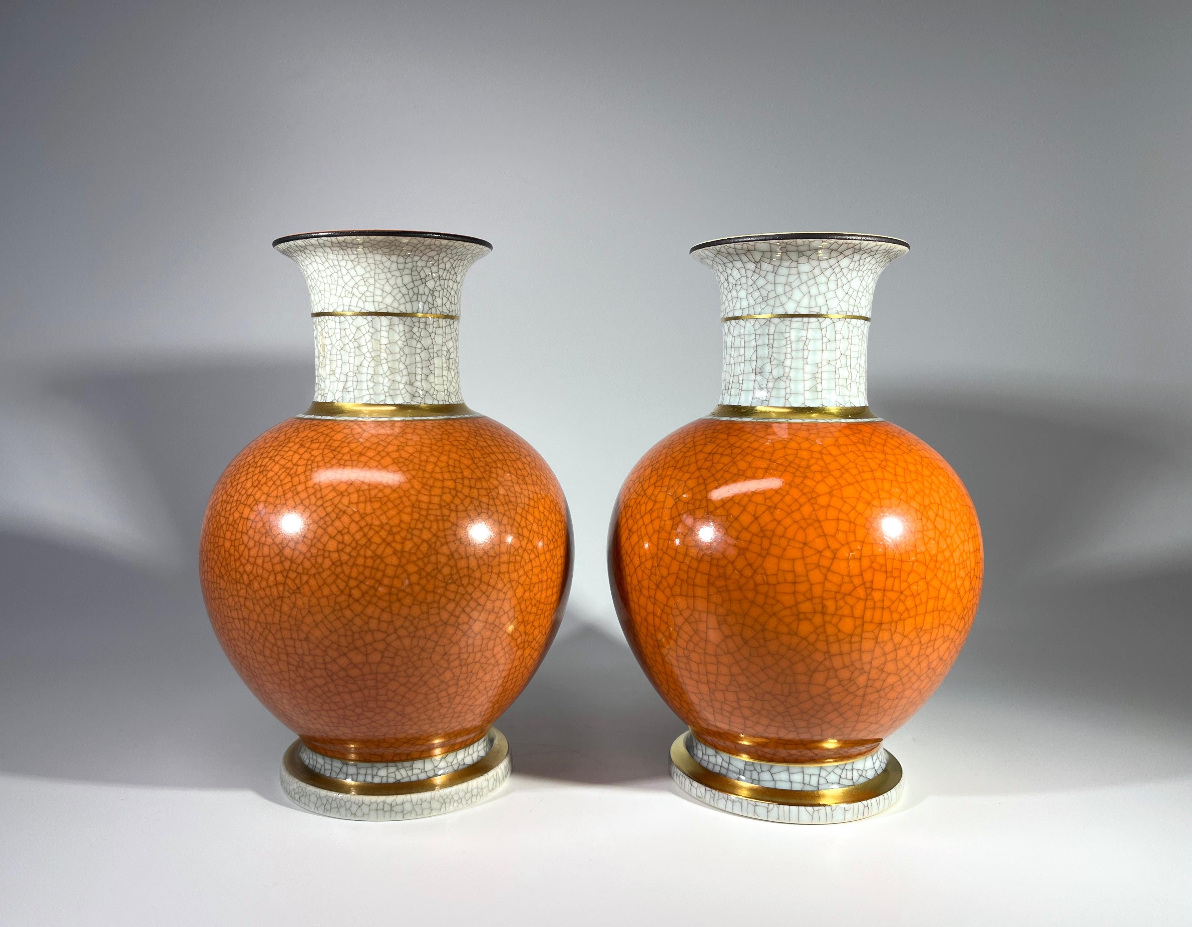 Pair of Thorkild Olsen for Royal Copenhagen porcelain terracotta and grey crackle glazed ball shaped vases with gilded banding on neck and base.
Although a pair, one vase dates 1951 and the other is circa 1968 to 1973
Stamped and numbered