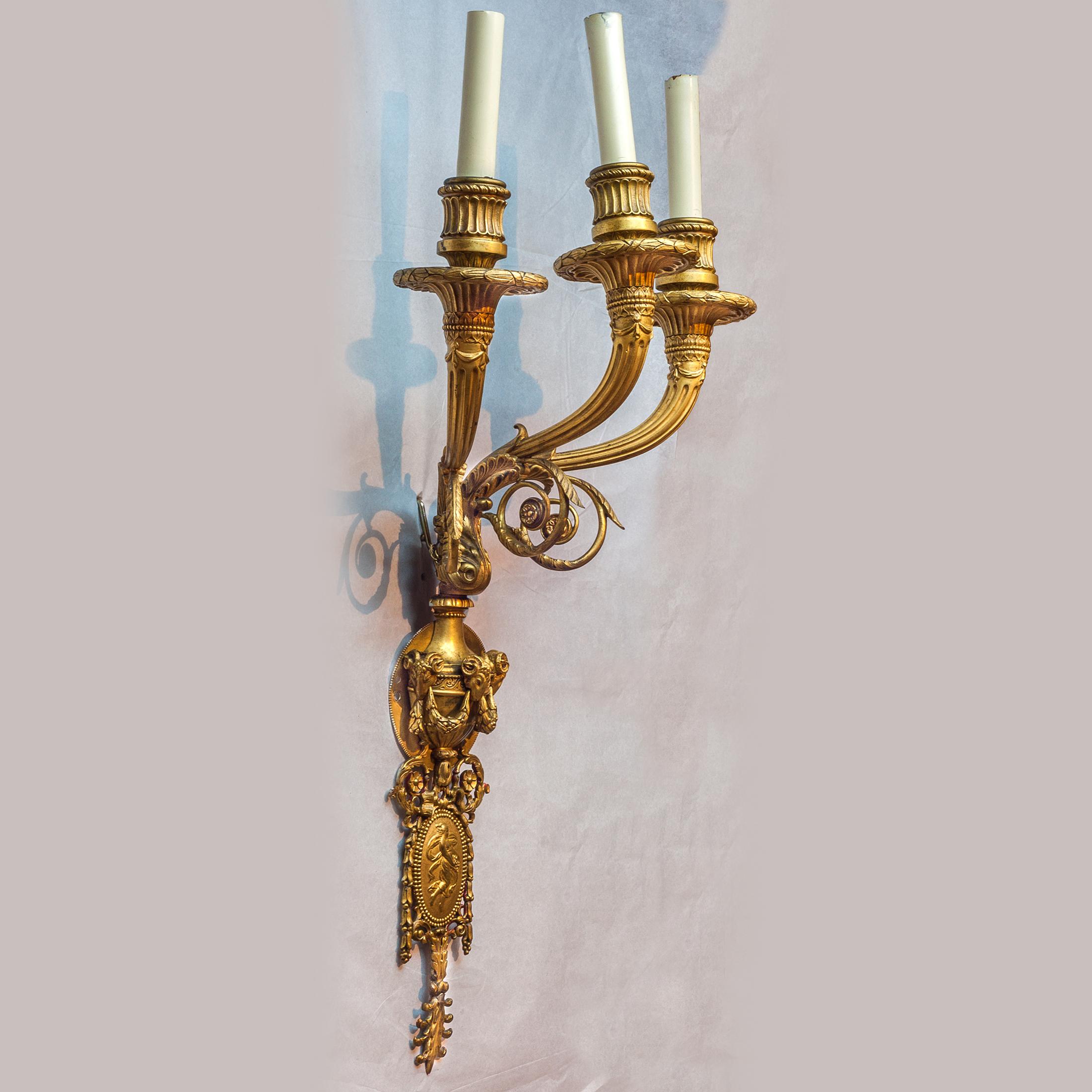 Exquisite pair of three-arm gilt bronze wall sconces.

Maker: attributed to Edward F. Caldwell Co. (1851-1914)
Origin: French/American
Size: 23 x 13 x 8 3/4 inches.