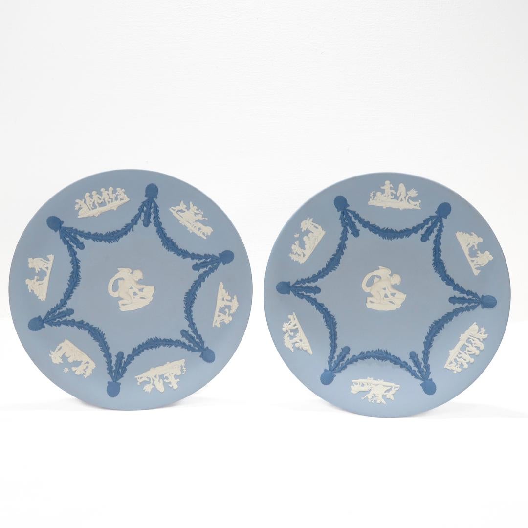 A fine pair of blue jasperware plates.

By Wedgwood.

In three colors with white cameos of cherubs or putti and a dark blue hexifoil garland on a light blue ground.

Each signed to the reverse in gold. (Also hand signed by Lord Wedgwood of Barlaston