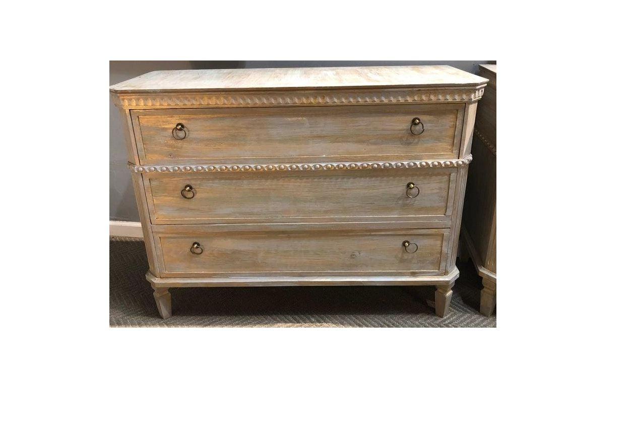 A pair of three drawer European chests painted with a gold wash, tapered legs and Swedish style.