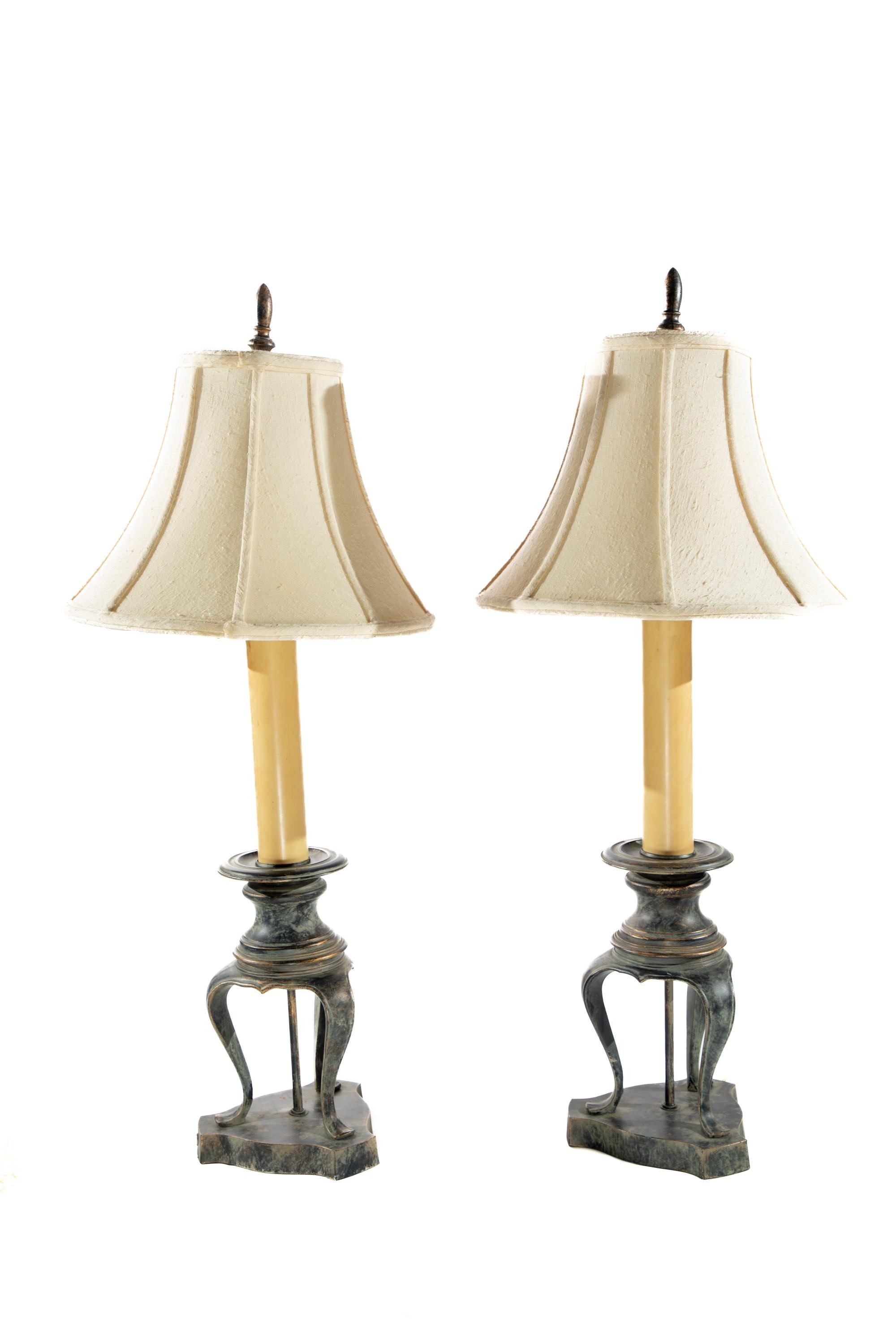 Pair of  table lamps with 3 feet on base in a candlestick style.