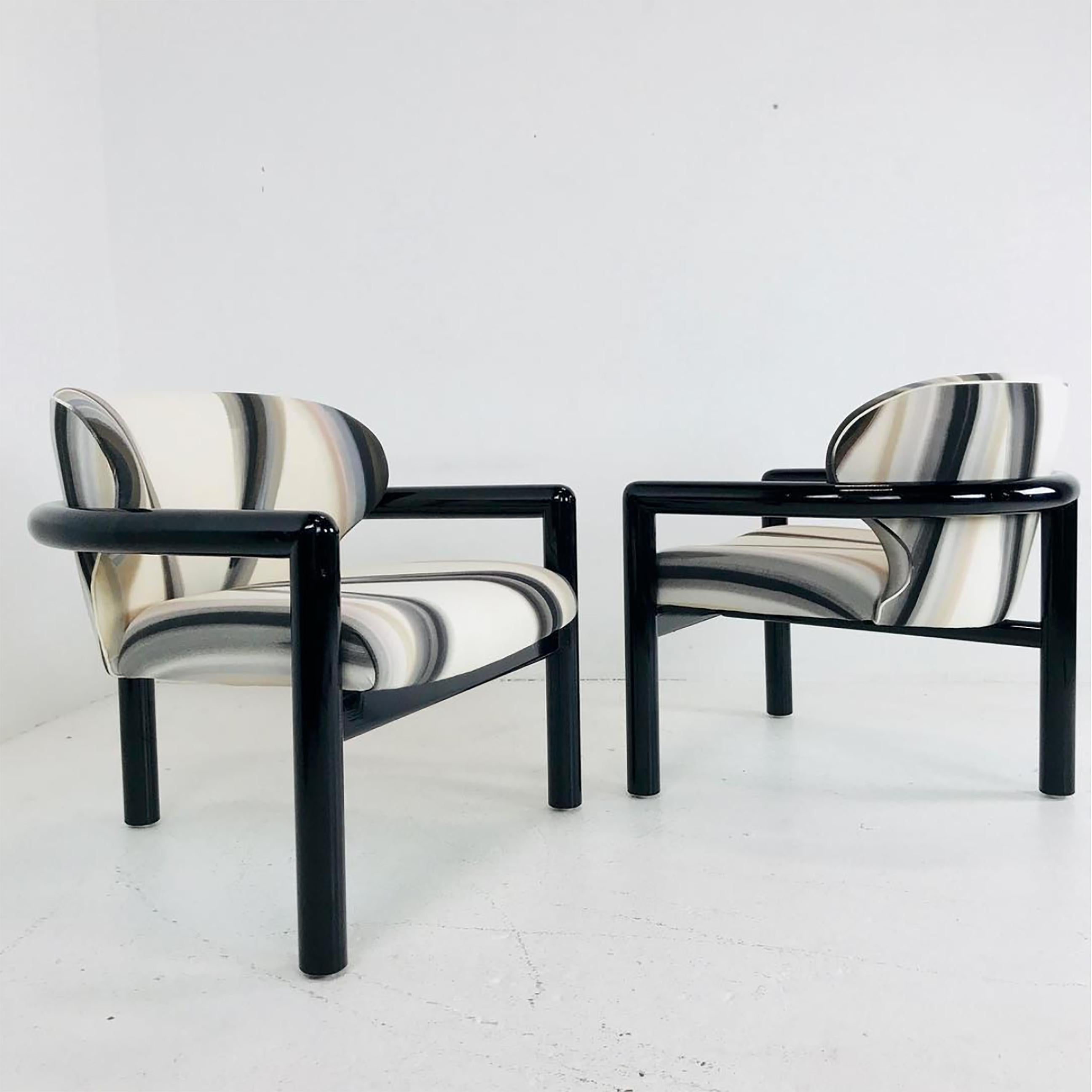 Pair of Kelly Wearstler style three-legged lounge chairs. These blacked lacquered chairs are upholstered in the black brown and cream fabric. There is wear due to age and use, but in over all good vintage condition. Refinishing and upholstery is