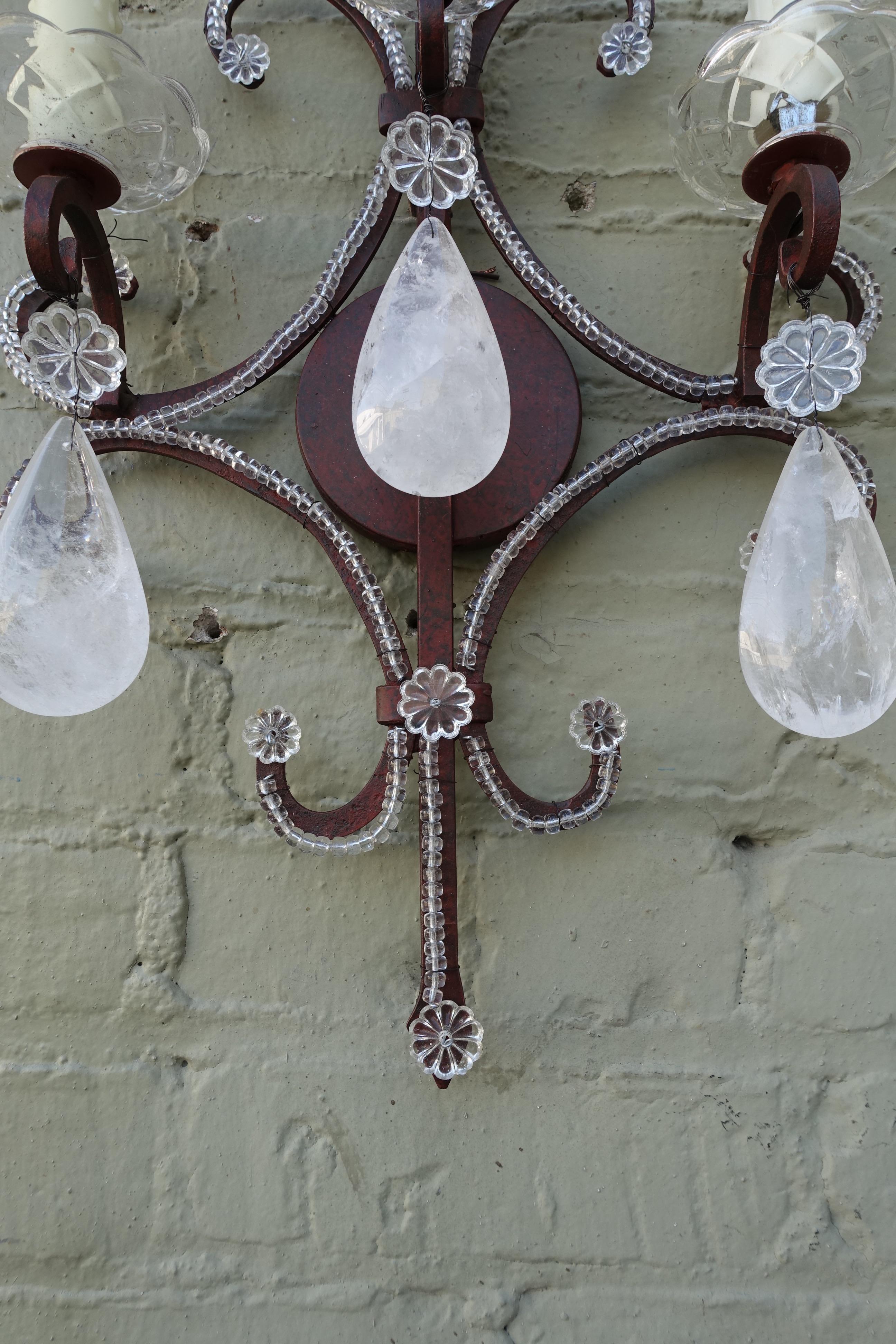 Pair of three-light wrought iron beaded sconces with almond shaped rock crystals. The sconces are newly rewired with drip wax candle covers. Newly rewired and ready to install.