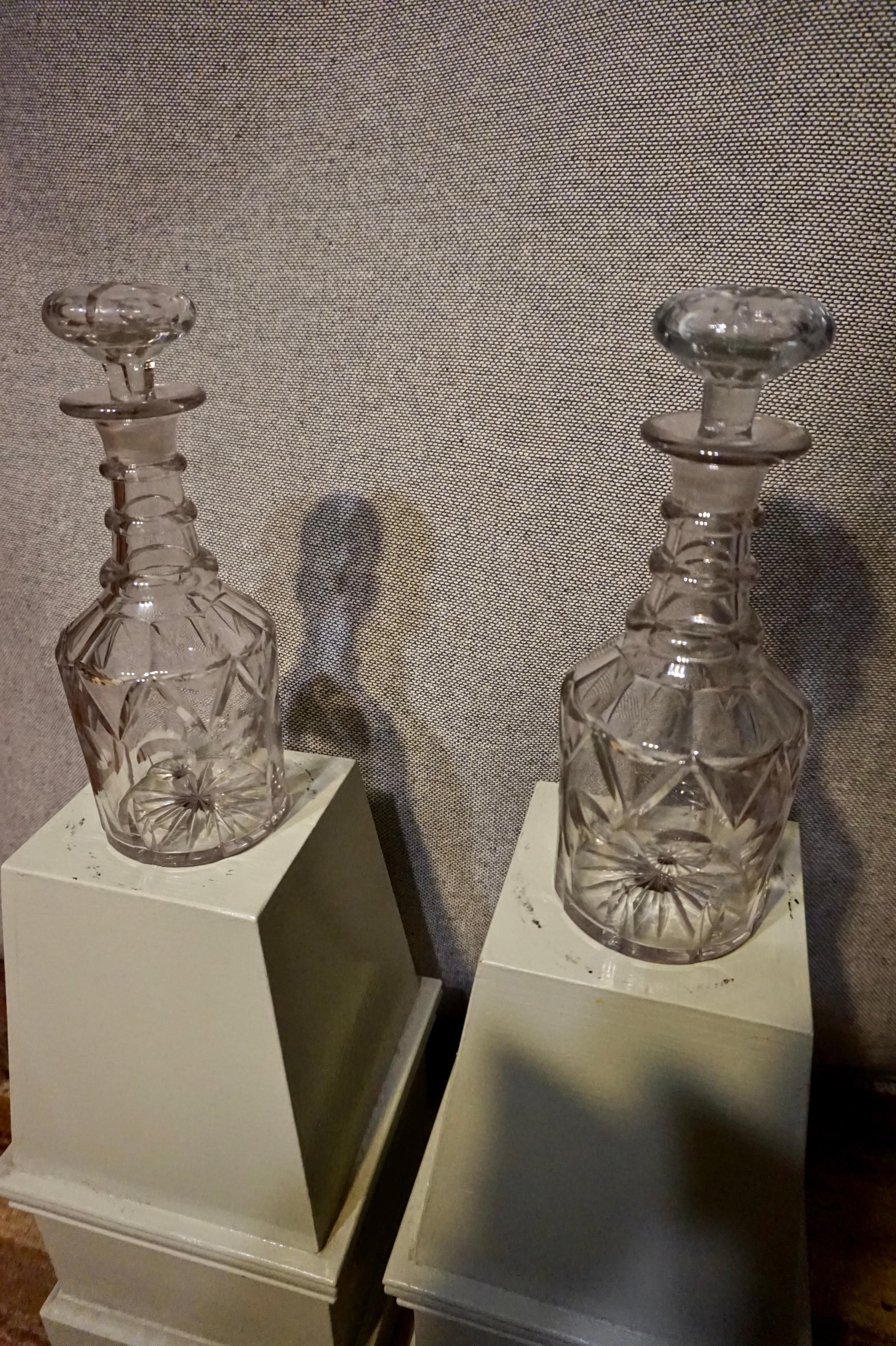 Fine 3 ringed decanters in good condition with original stoppers, bevelling and pin wheel base pattern. Gravitas!
