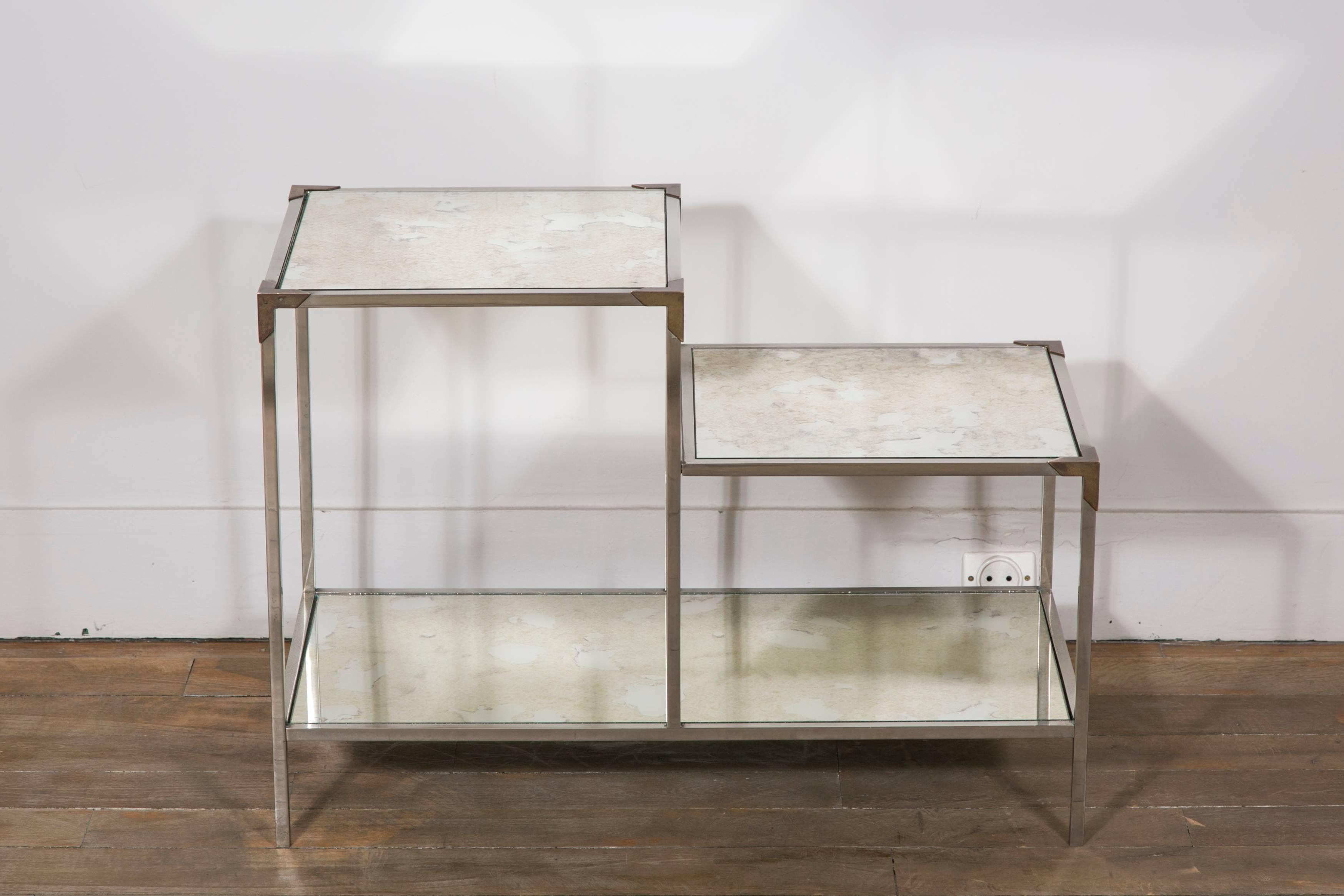 Pair of nickelled metal end tables, with mirrored tops and brass details.
France, 1960s.

Dimensions:
Height 50 cm / 19.68 inches.
Intermediary height 35 cm / 13.77 inches.
Length 70 cm / 27.55 inches.
Depth 35 cm / 13.77 inches.
 