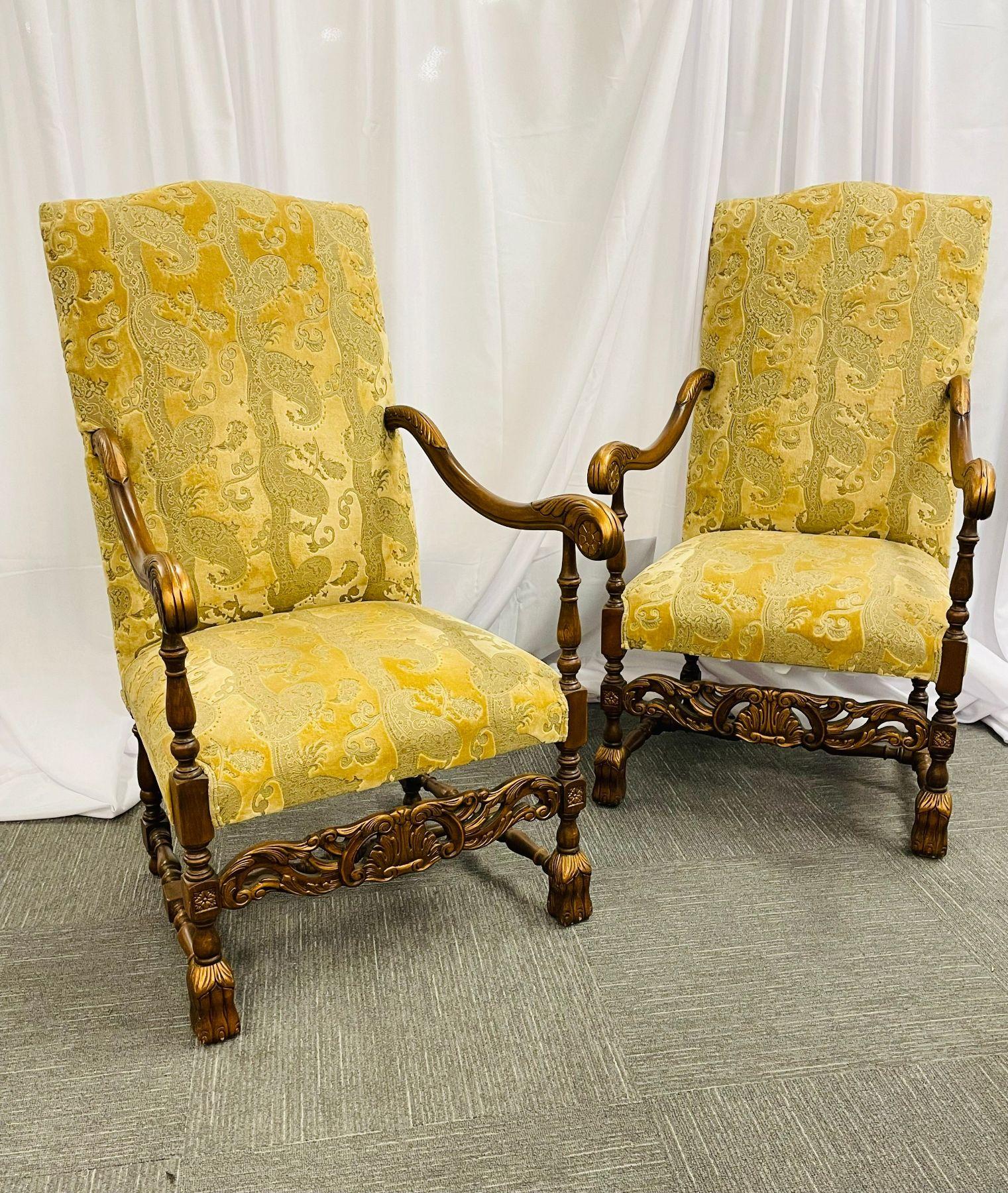 Pair of Throne chairs or fauteuils each with an arched back and padded seat joined to open arms with parcel-gilt foliate- and rosette-carved hand rests, and raised on turned legs joined by an H-form stretcher with a carved and pierced apron,