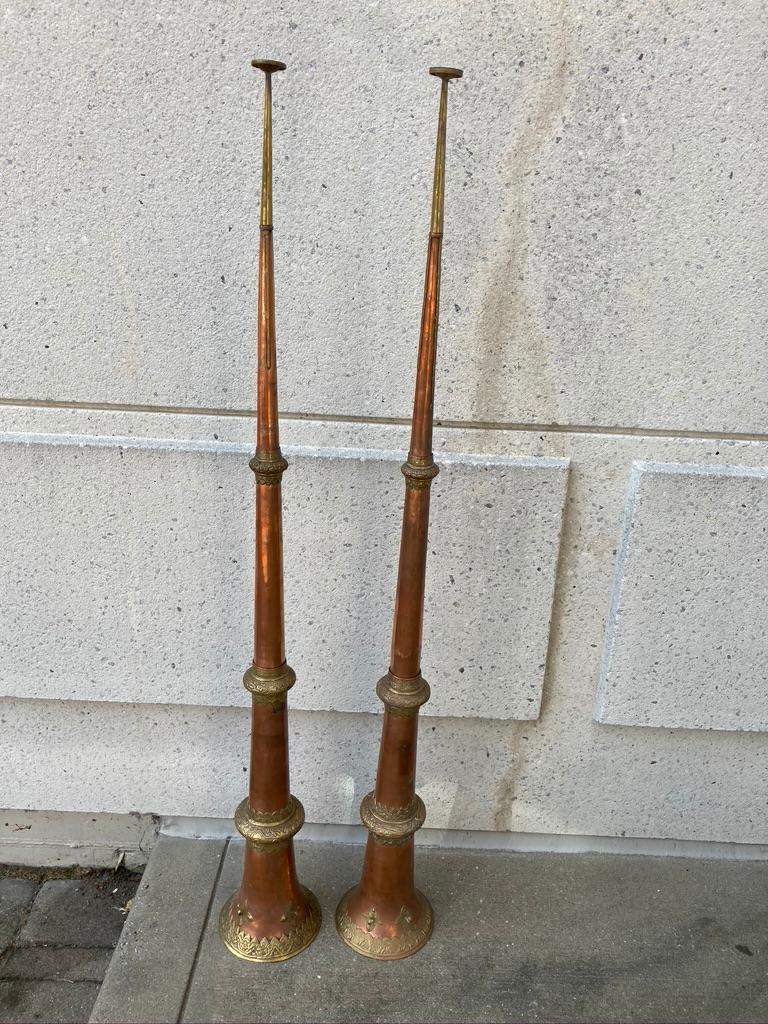 Pair of Tibetan ritual copper trumpets with repousse brass decorative bands depicting dragons. These tall Dungchen horns telescope down into a compact size for storage. Both have 2 rings for hanging. Or they can be placed as singular sculpture or