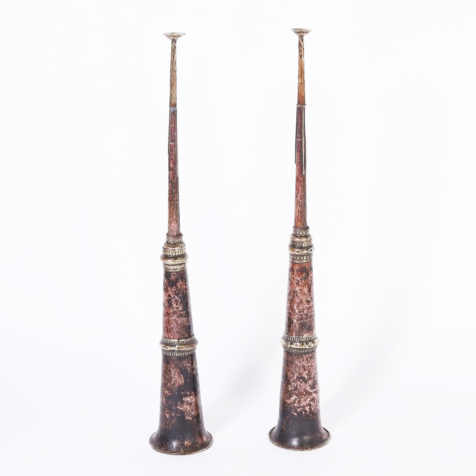 Intriguing pair of 19th century Tibetan horns hand crafted with copper and brass in a charming rustic technique featuring a time turned lush patina.

Measure: 50.5
