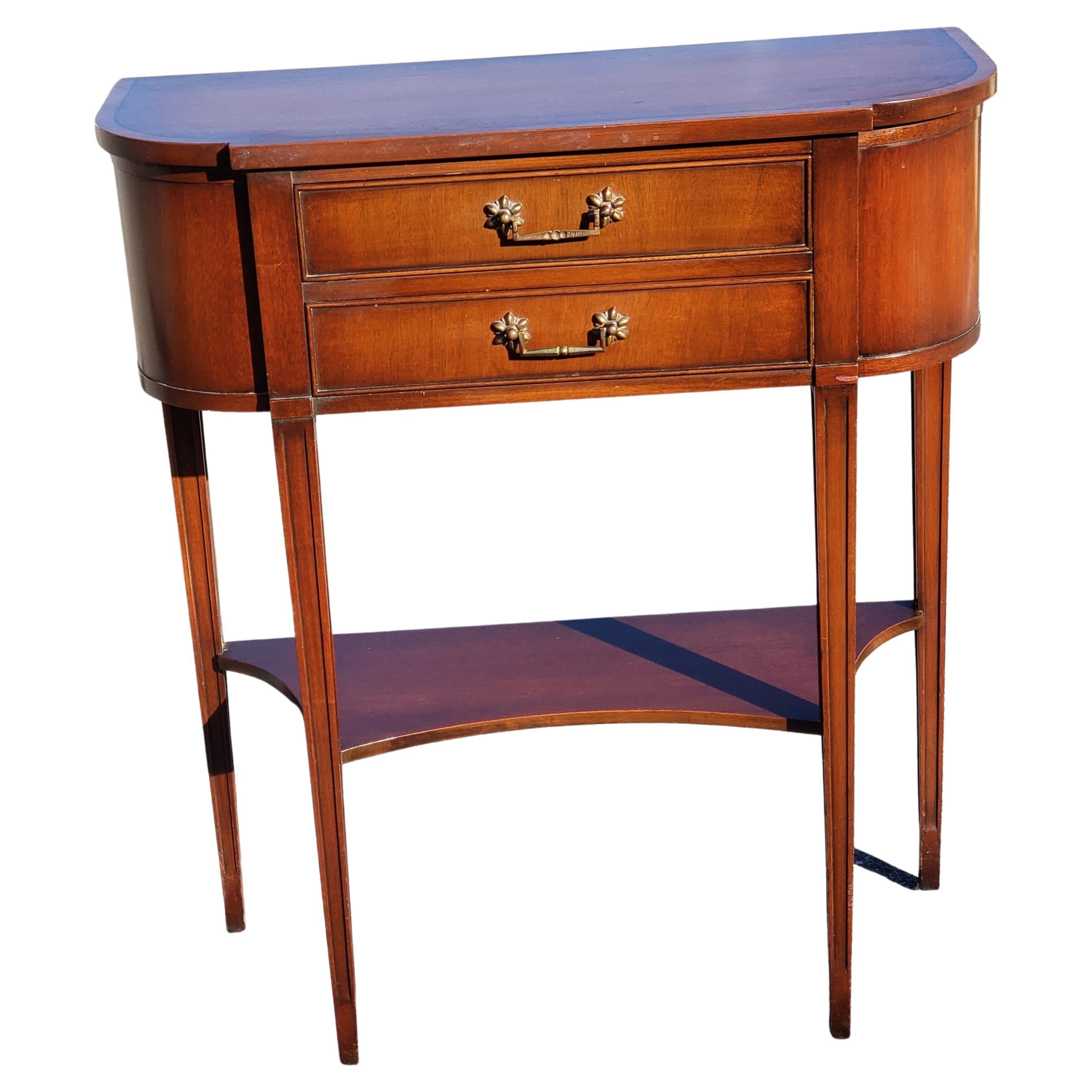 Marvelous Pair of regency banded mahogany regency console tables, circa 1940s.
Features rare two drawers with bottom shelf. Original hardware. Good vintage condition. 
Good vintage condition. 

W1050922.