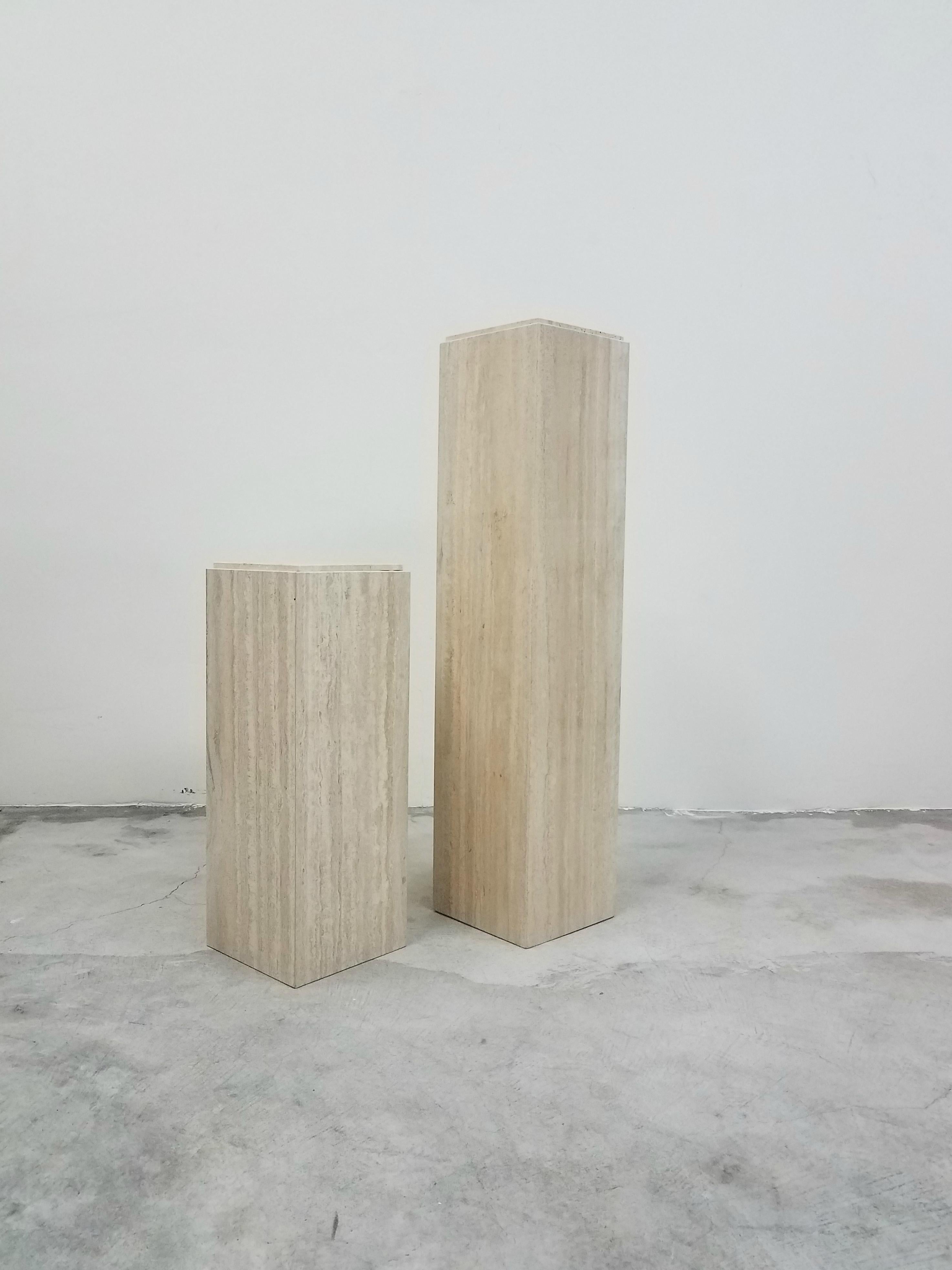 A beautiful coordinating pair of square Italian travertine pedestals. Perfect to display your favorite sculpture, bust or art piece. Pedestals are polished and have a unique top edge detail.

Pedestals are in excellent condition.

Pricing is for