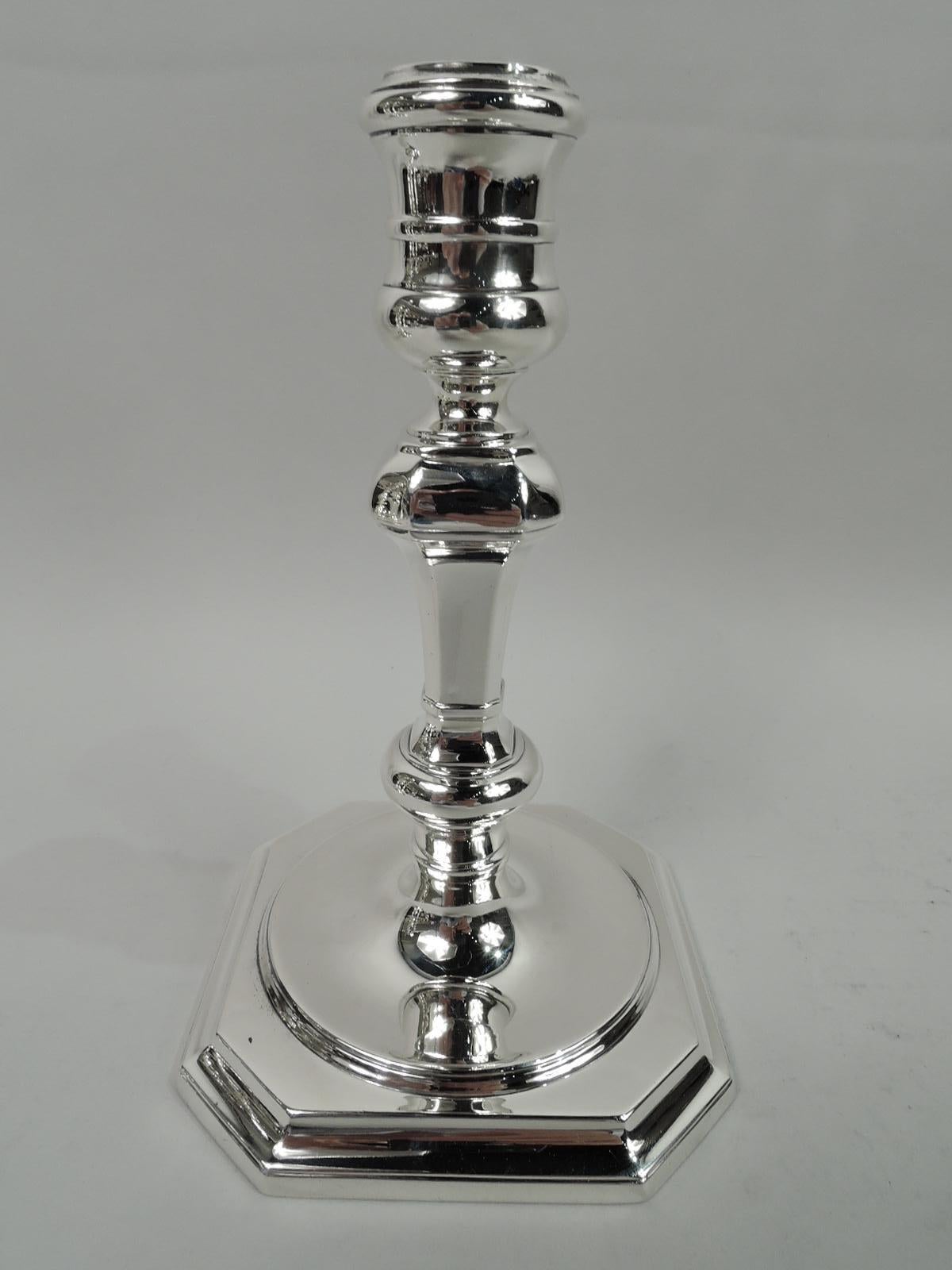 Pair of Colonial sterling silver candlesticks. Made by Tiffany & Co. in New York, ca 1917. Each: Girdled spool socket on faceted and knopped shaft; round foot mounted to chamfered square base. Both fully marked including maker’s stamp, pattern no.